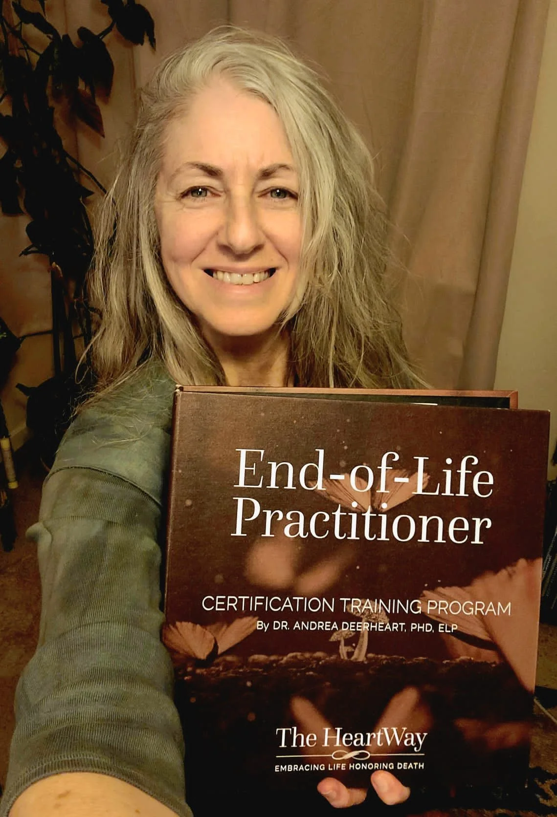 Person holding "End-of-Life Practitioner" book.
