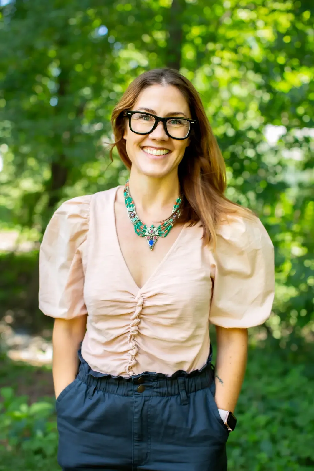 white woman with glasses standing outside