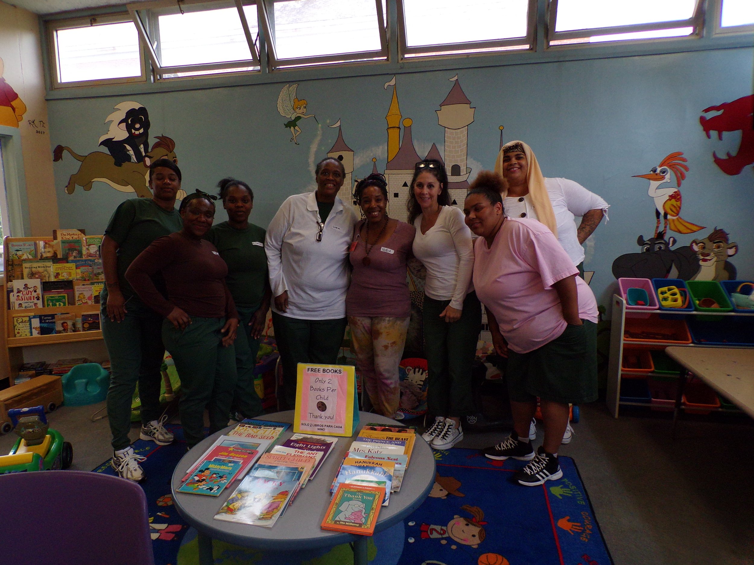 women gathered around a nursery table smiling