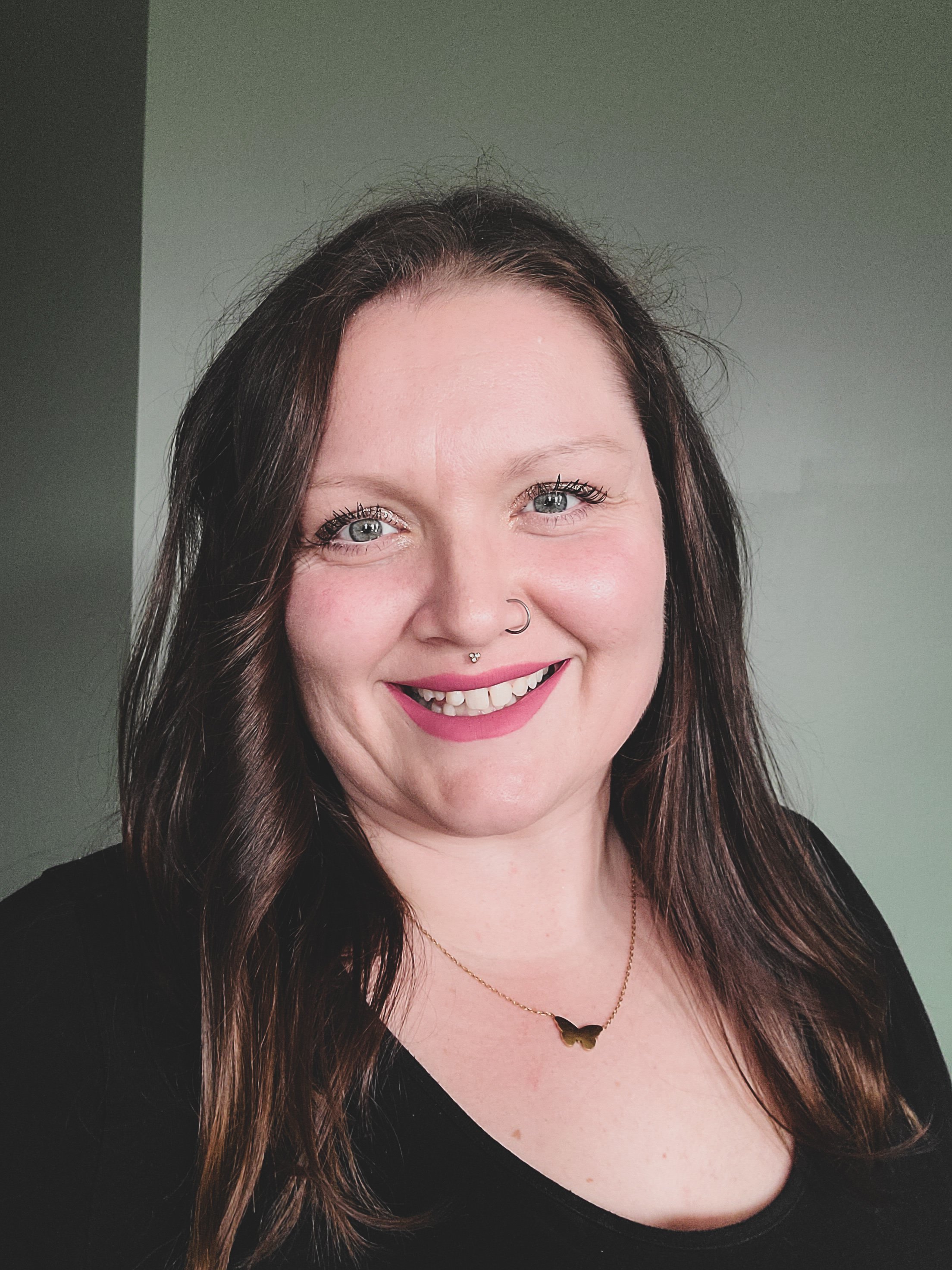head shot of white woman with long brown hair