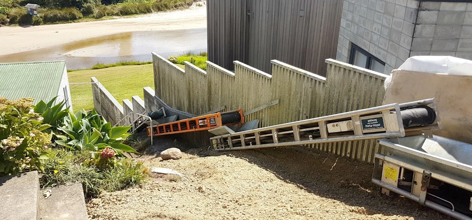 4 Portable and modular conveyor belts connected in series hauling fill materials up hill to construction site