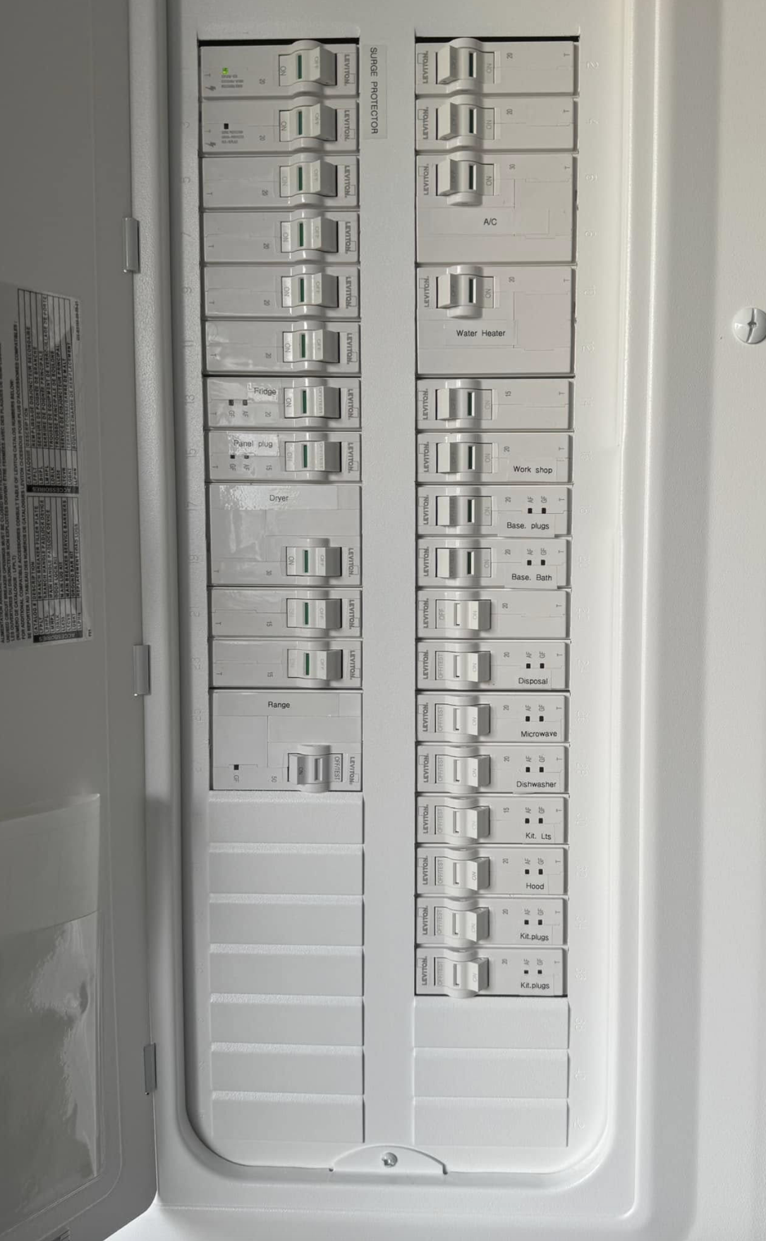 Electrical circuit breaker panel with labeled switches for appliances and areas of a house.