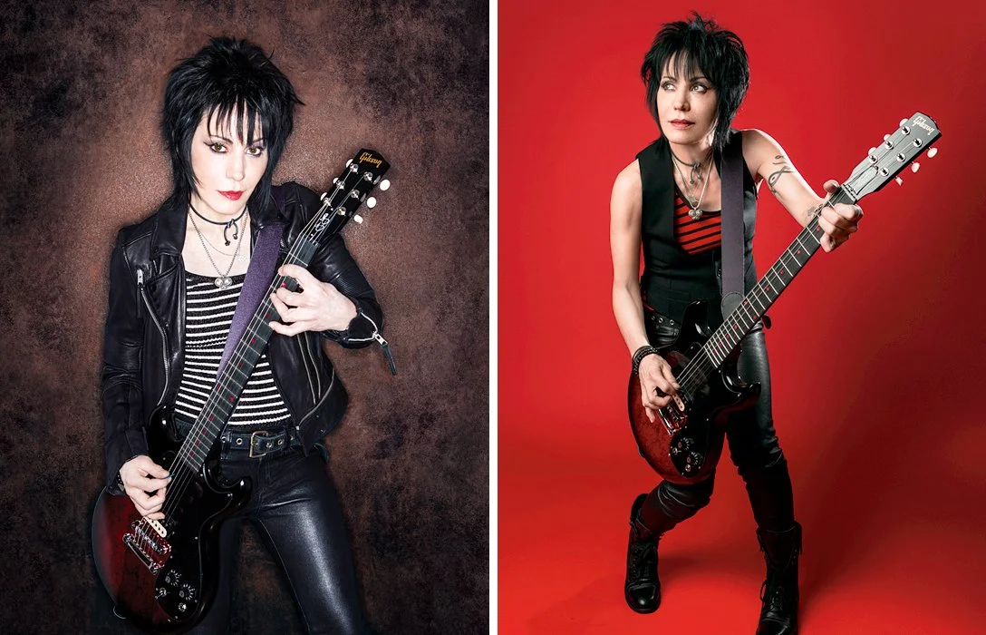 Two women with short black hair, wearing black and red striped tops and black leather clothing, each holding an electric guitar against different backgrounds, one textured brown and one red.