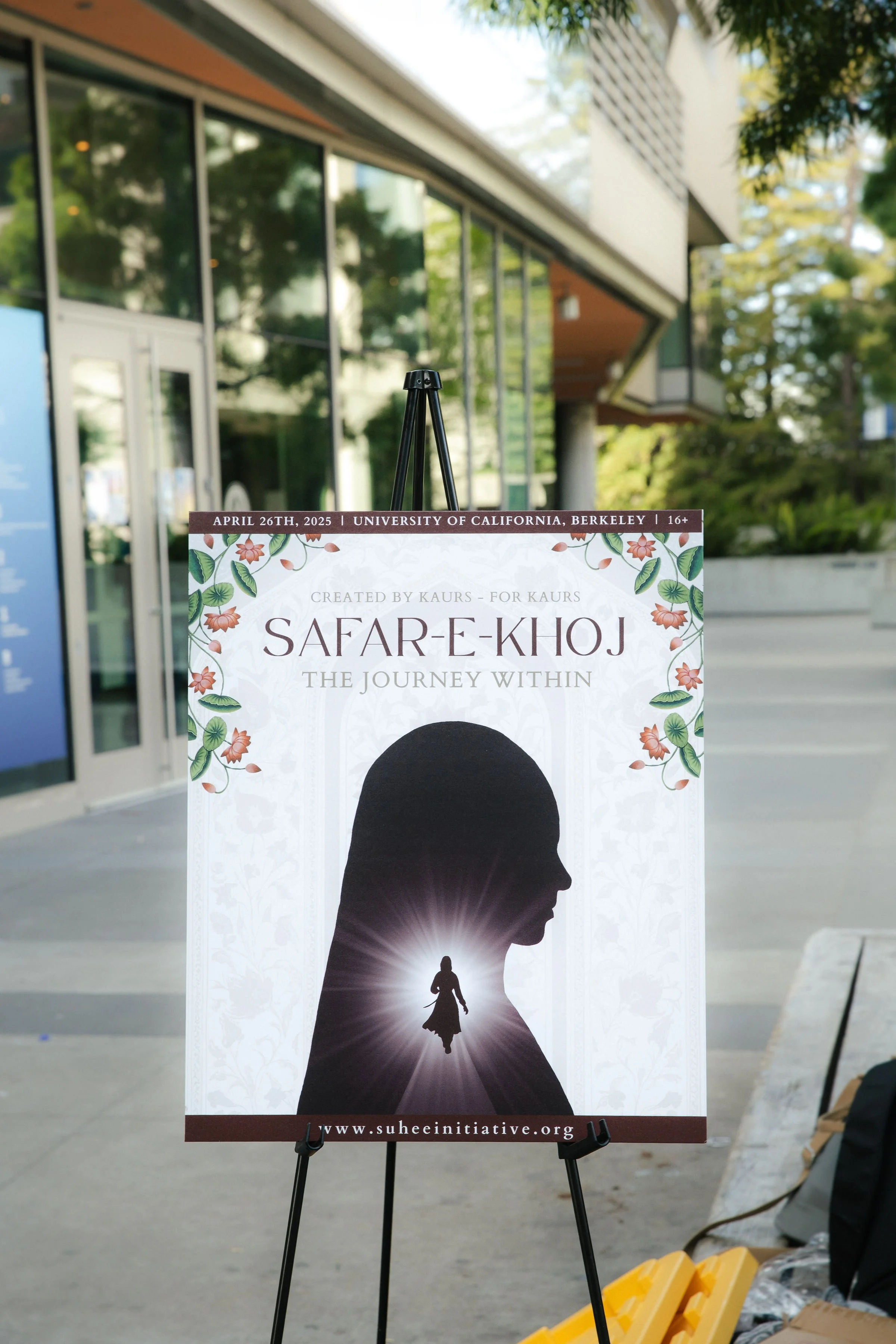 Event poster displayed on an easel outside a modern building, advertising 'SAFAR-E-KHOJ: The Journey Within,' scheduled for April 26th, 2025 at the University of California, Berkeley.