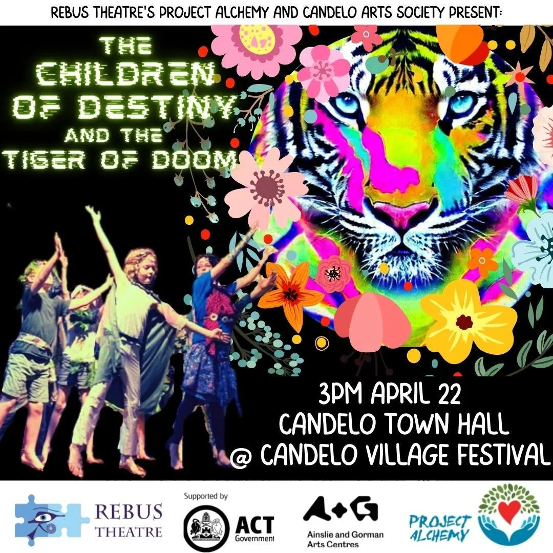Event poster for a performance titled "The Children of Destiny and the Tiger of Doom" by Rebus Theatre's Project Alchemy and Candelo Arts Society, scheduled for 3 PM on April 22 at Candelo Town Hall during Candelo Village Festival. The poster features a vibrant, multicolored tiger face surrounded by flowers and depicts children dancing in a line.