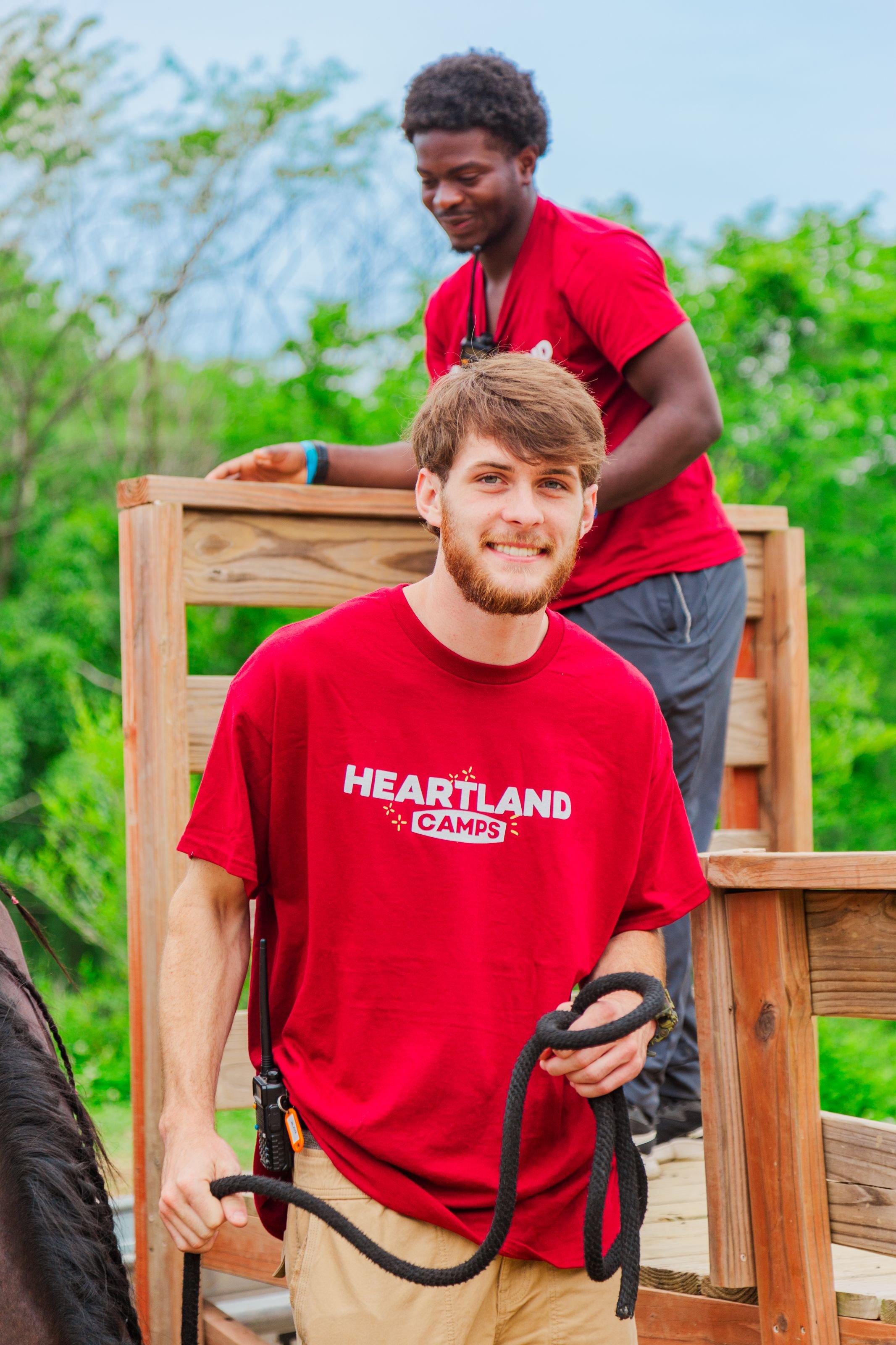 Heartland Christian Camp Paid Gap Year Internship men standing and smiling with a horse Outside Near Kansas City, Missouri