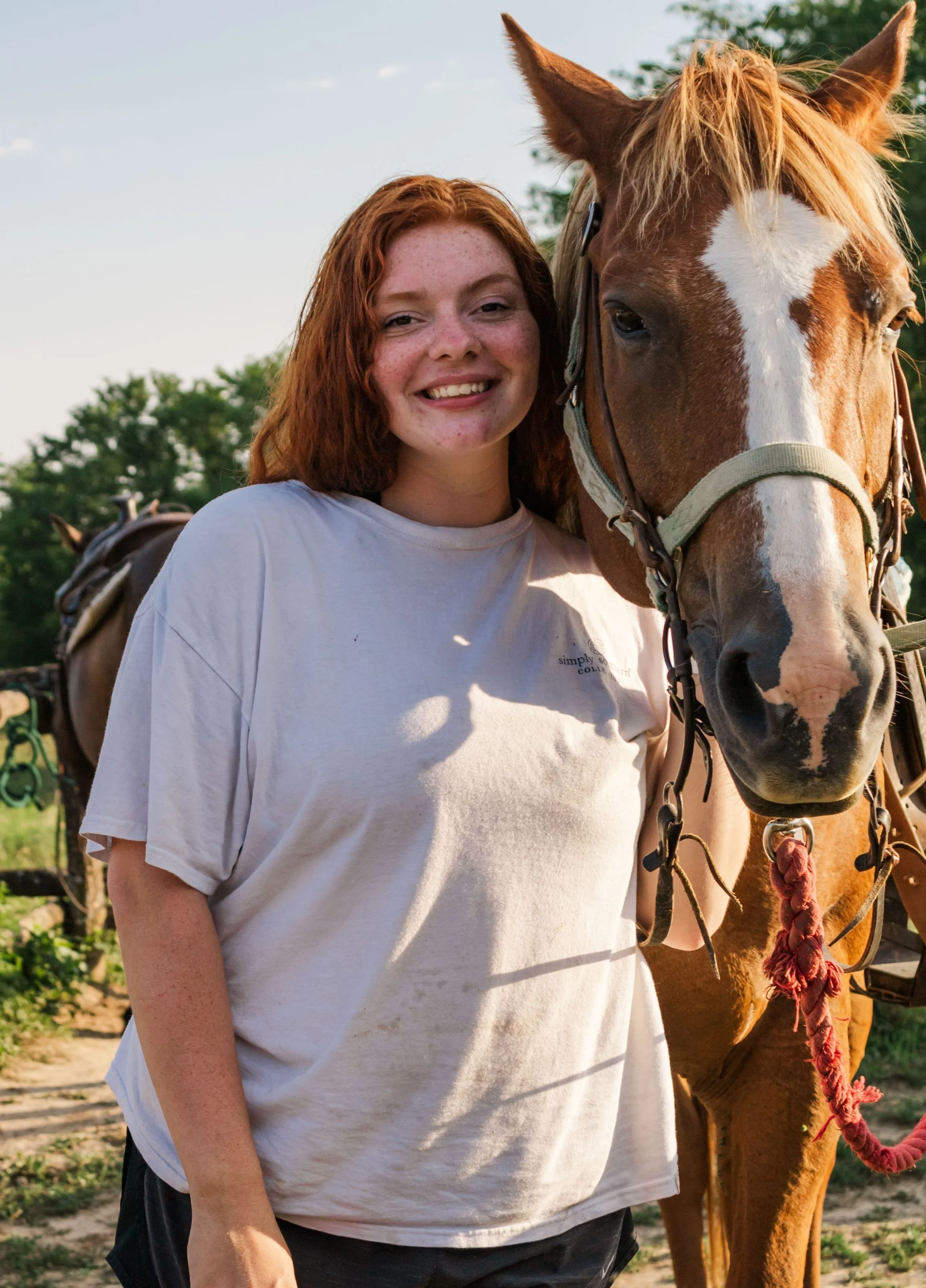 Heartland Christian Camp Paid Gap Year Internship woman standing and smiling with a horse Outside Near Kansas City, Missouri