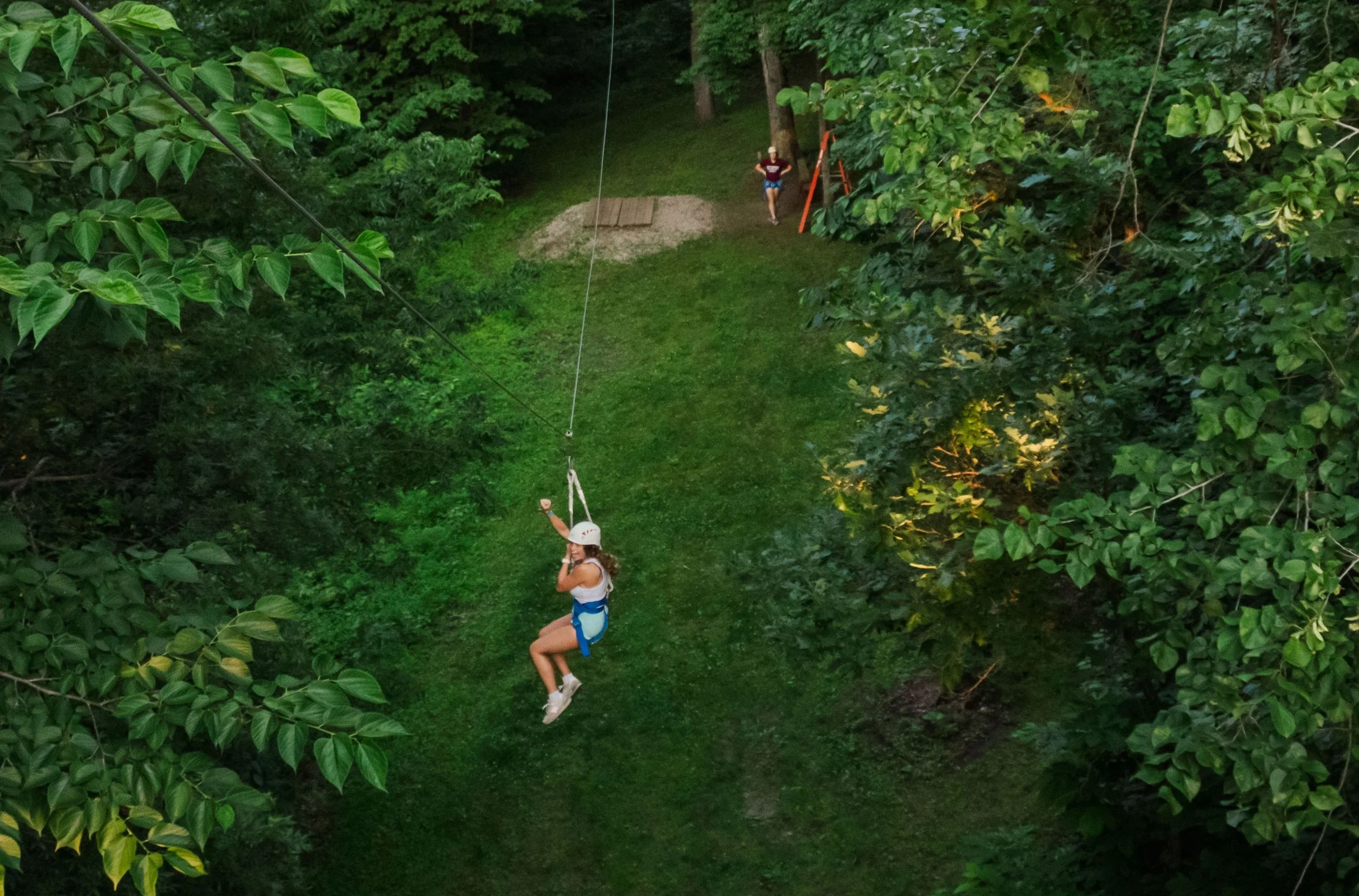 Heartland Christian Camp Paid Gap Year Internship women ziplining and smiling Outside Near Kansas City, Missouri