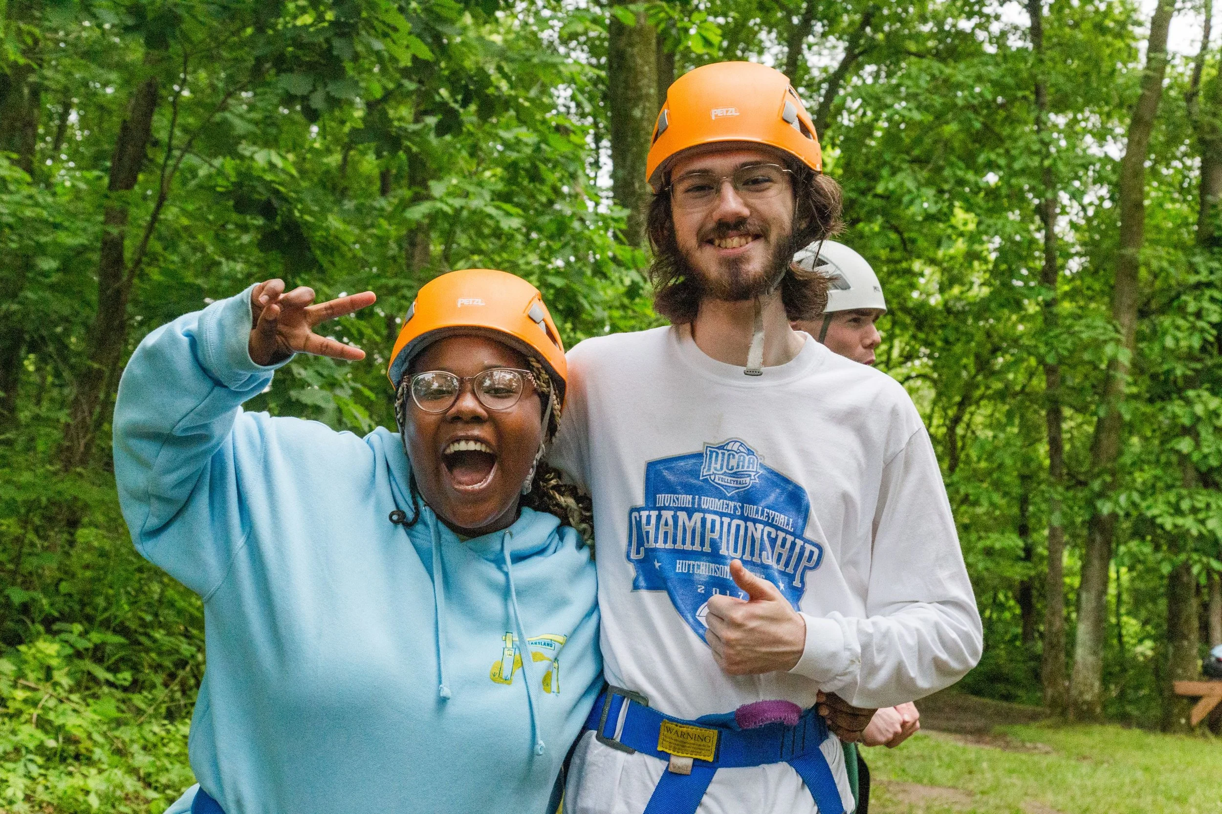 Heartland Christian Camp Paid Gap Year Internship Man and Woman Standing and Smiling Together in helmets and harnesses for climbing Outside Near Kansas City, Missouri