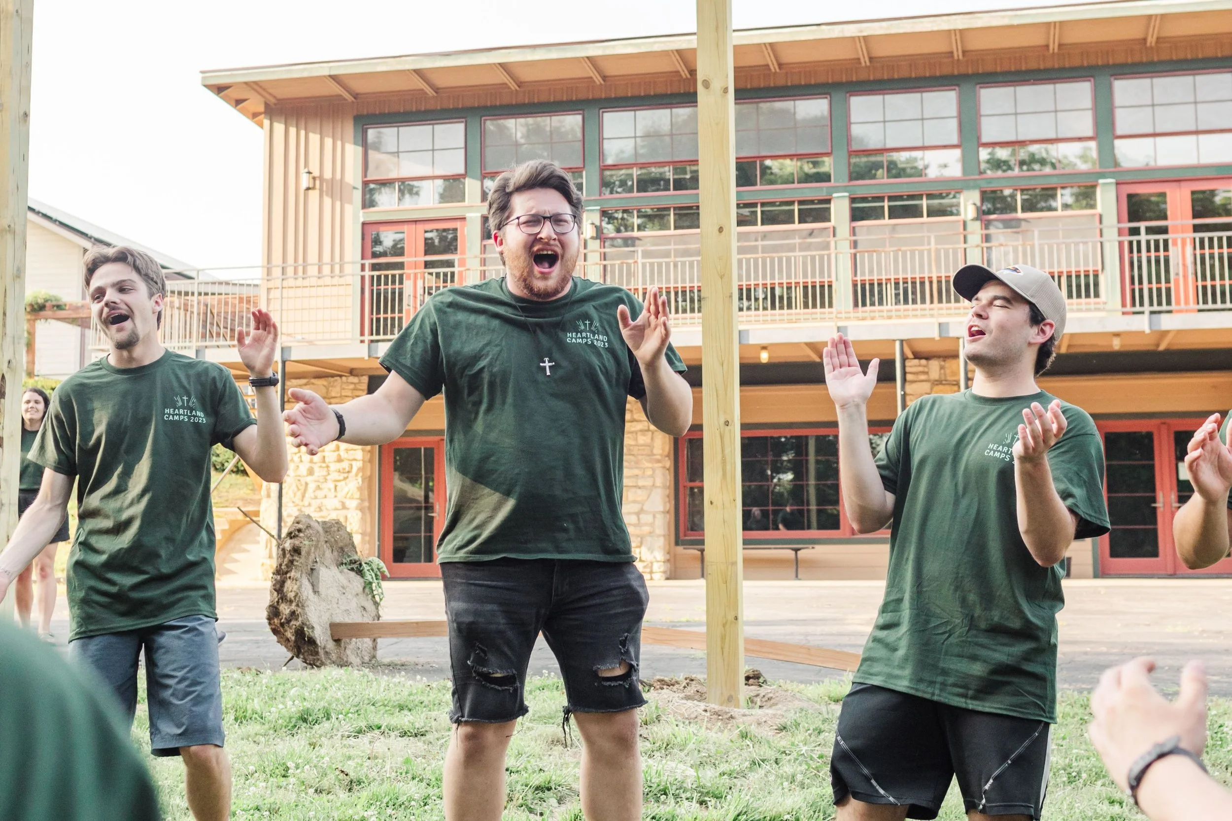 Heartland Christian Camp Paid Gap Year Internship Men and Women jumping and Singing Together Outside Near Kansas City, Missouri