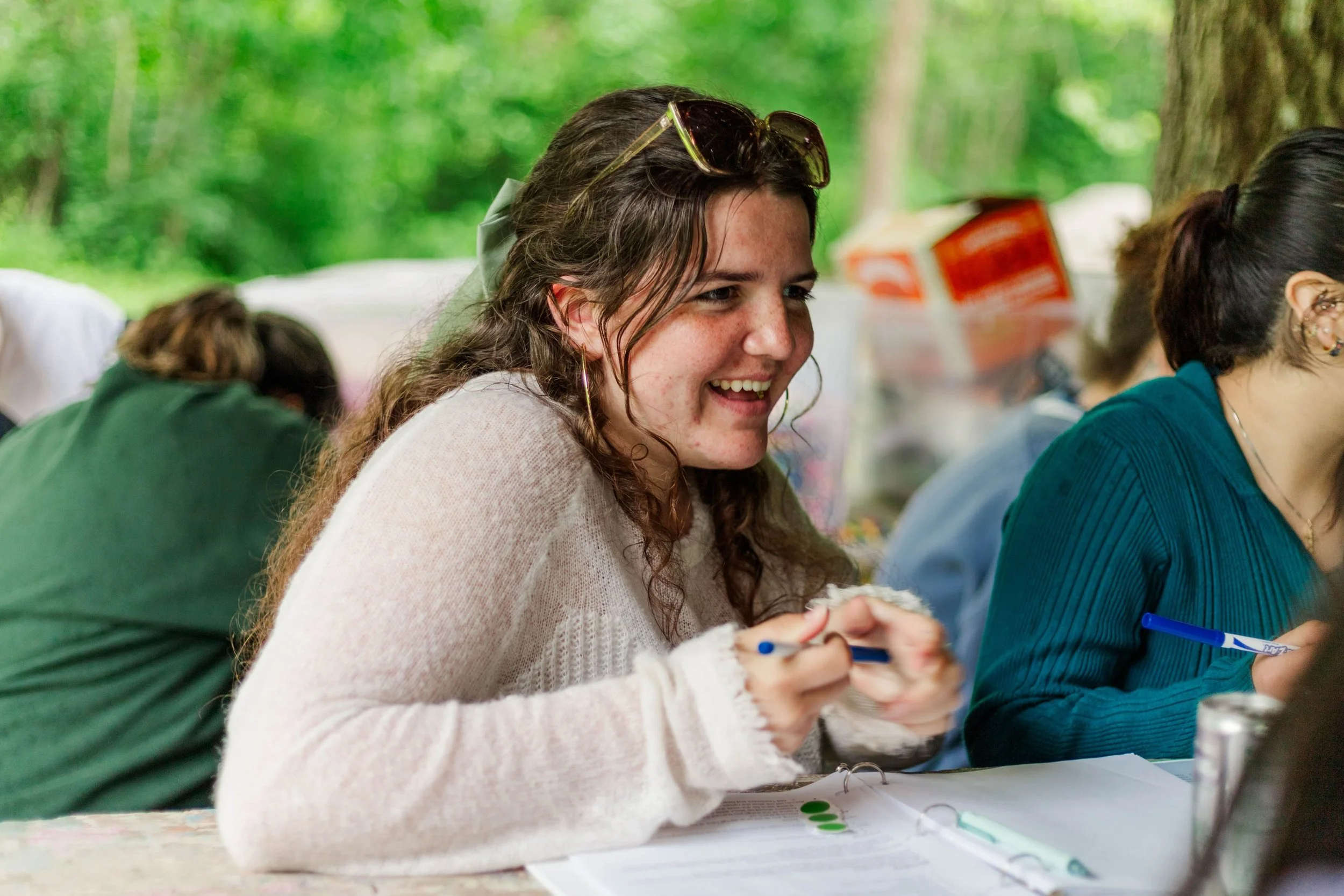 Paid Gap year at Heartland Christian Camp woman deciding what to write in a journal