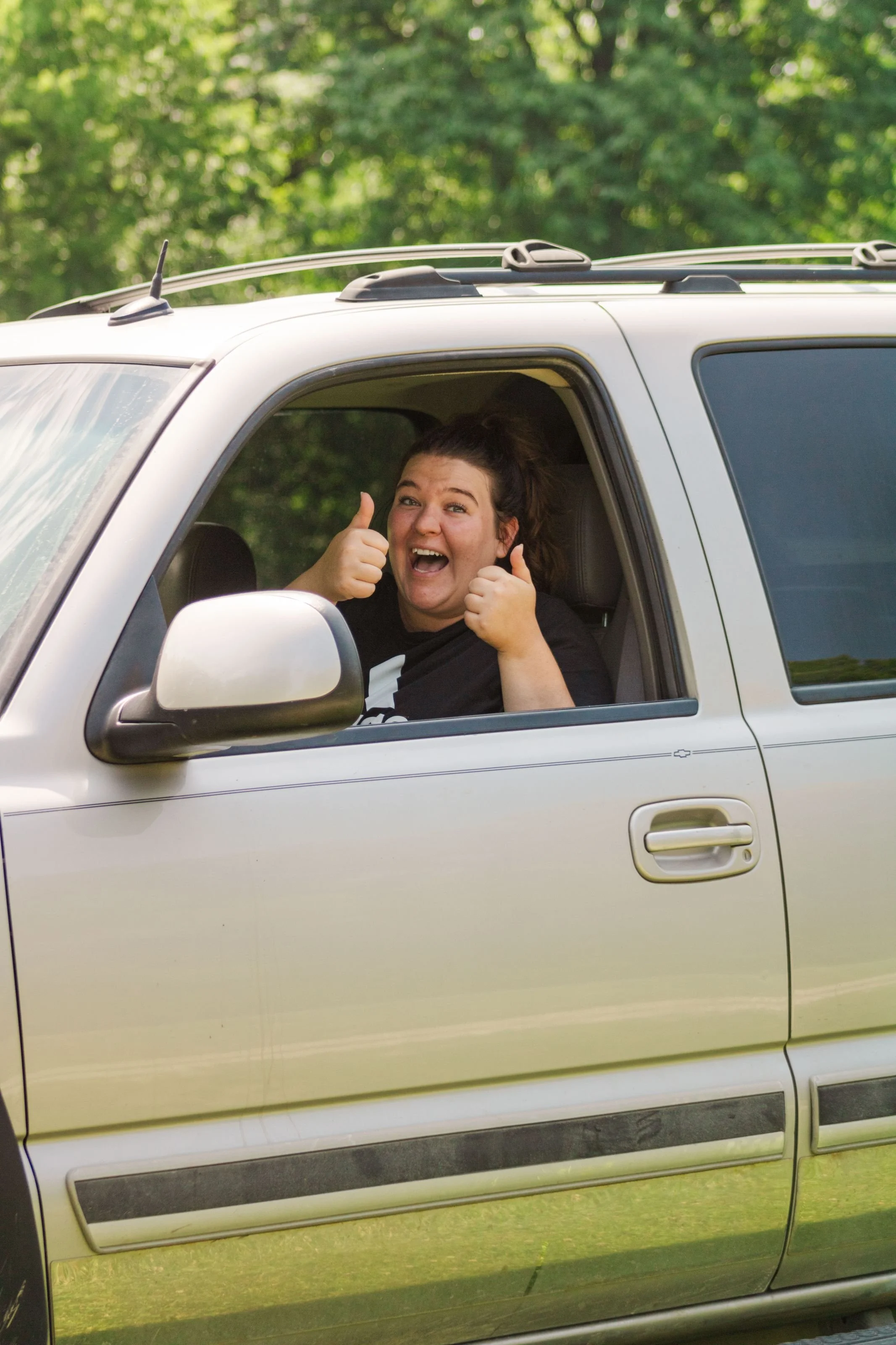 Heartland Christian Camp Paid Gap Year Internship woman giving thumbs up and smiling in a car Near Kansas City, Missouri