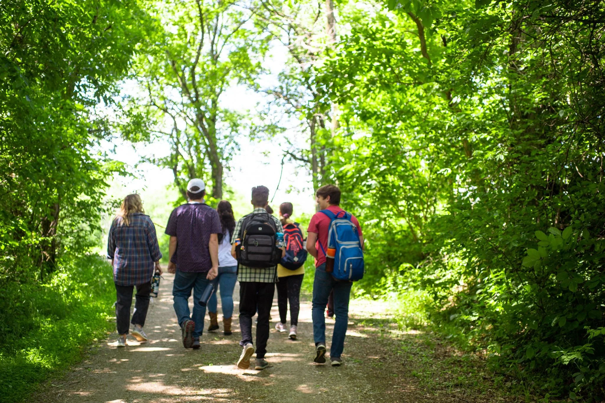 Heartland Christian Camp Paid Gap Year Internship Men and Women walking in a green forest Together Outside Near Kansas City, Missouri