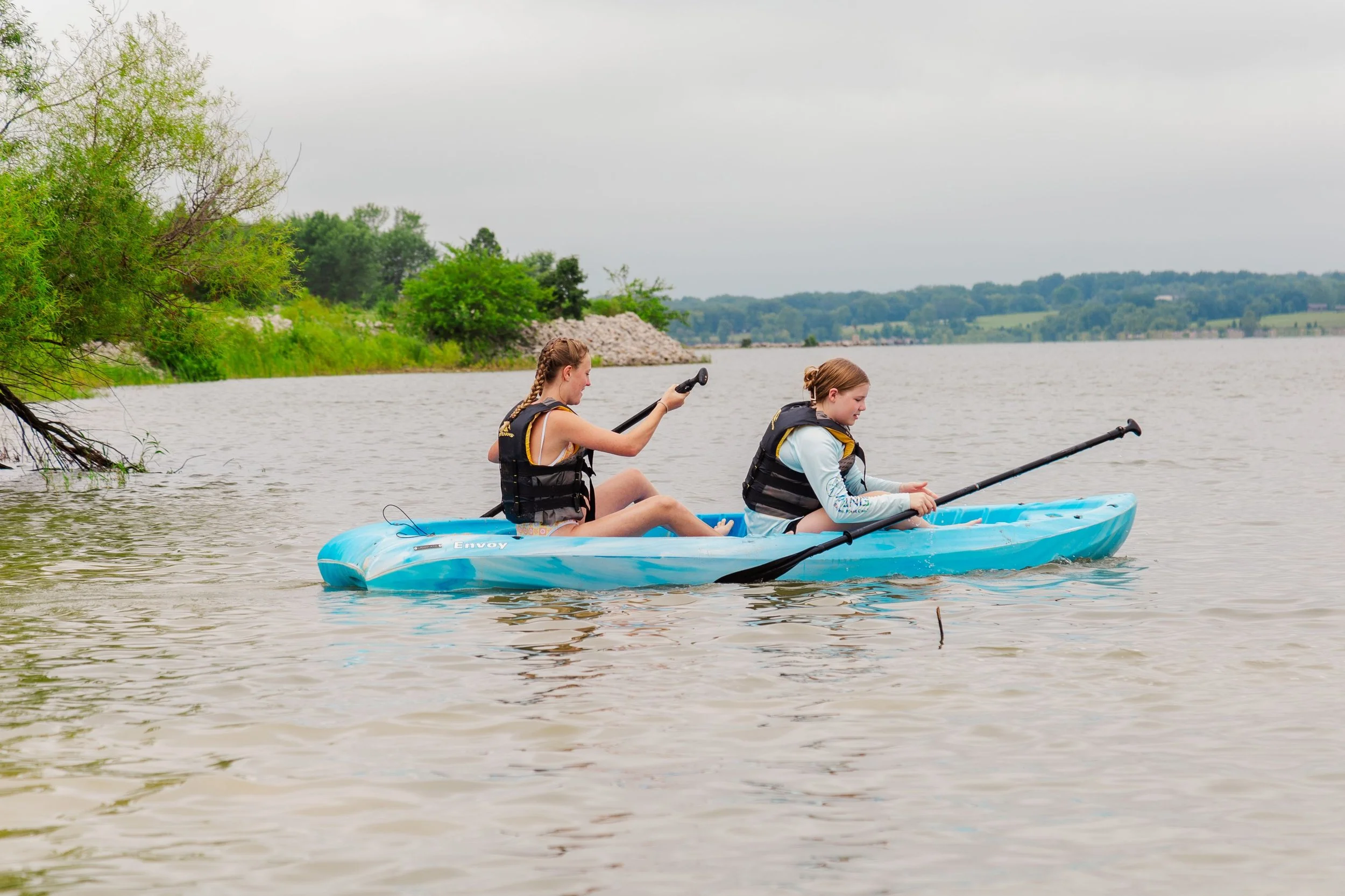 Heartland Christian Camp Paid Gap Year Internship Women Sitting in a kayak Together Outside Near Kansas City, Missouri