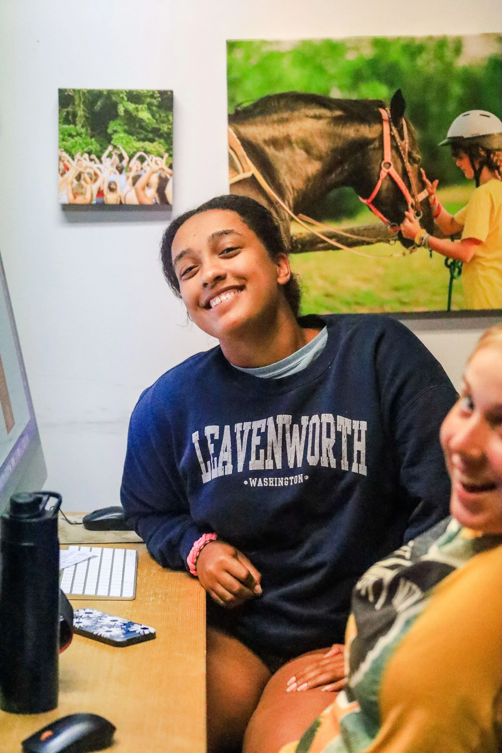 Heartland Christian Camp Paid Gap Year Internship women working in an office on computers while smiling near Kansas City, Missouri