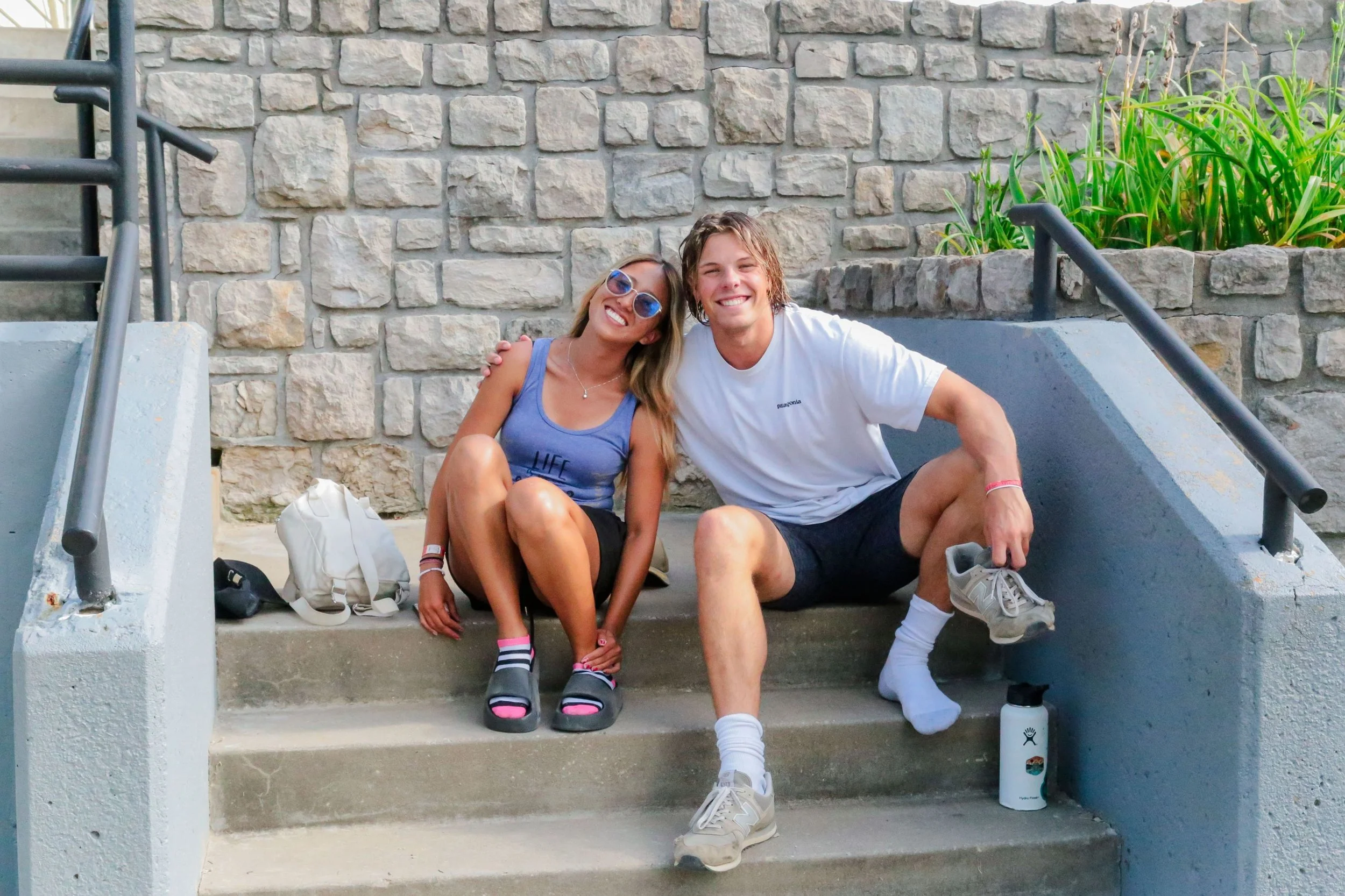 Heartland Christian Camp Paid Gap Year Internship man and woman sitting and smiling Outside Near Kansas City, Missouri