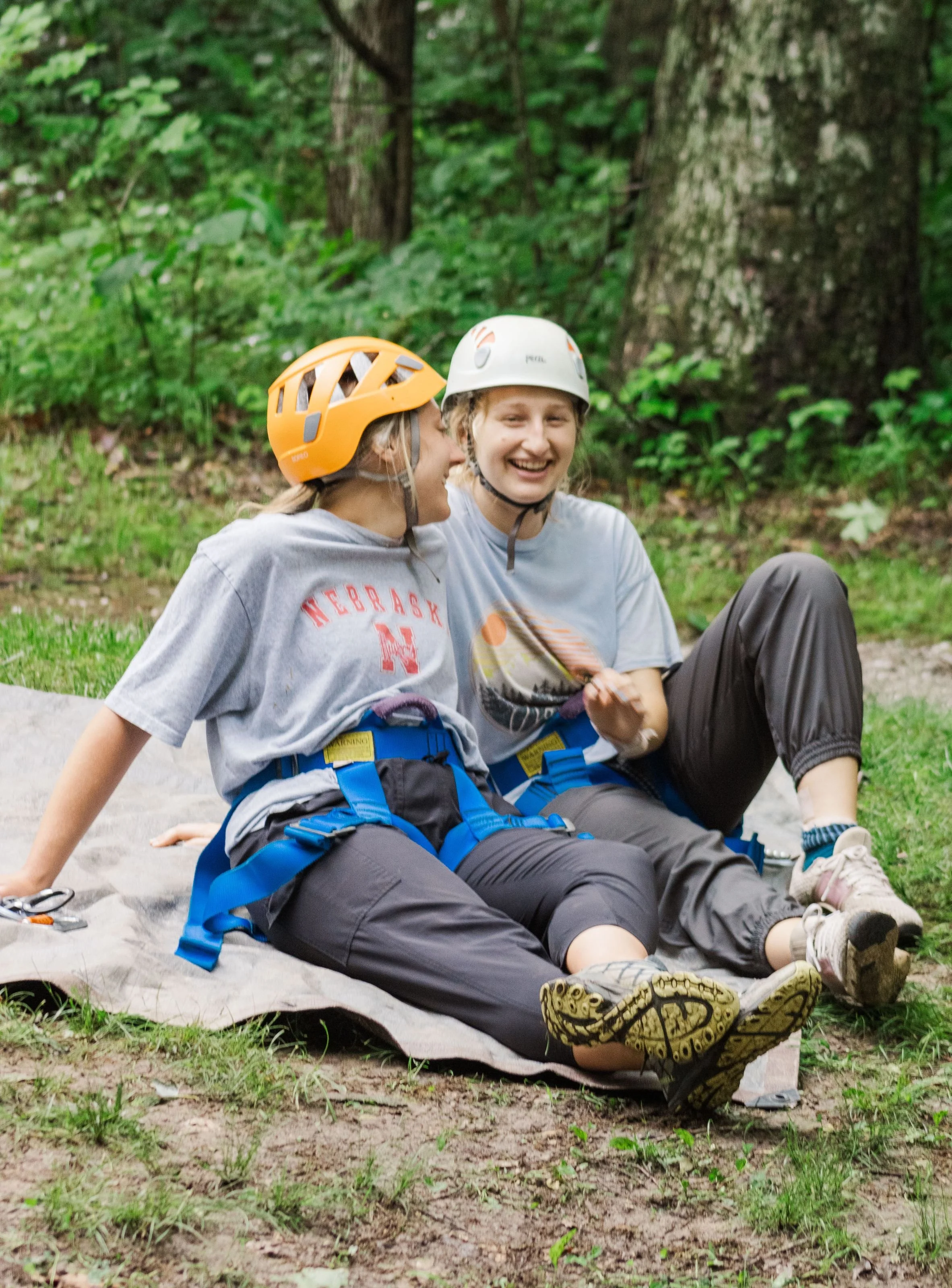 Heartland Christian Camp Paid Gap Year Internship two women sitting and Smiling Together Outside Near Kansas City, Missouri