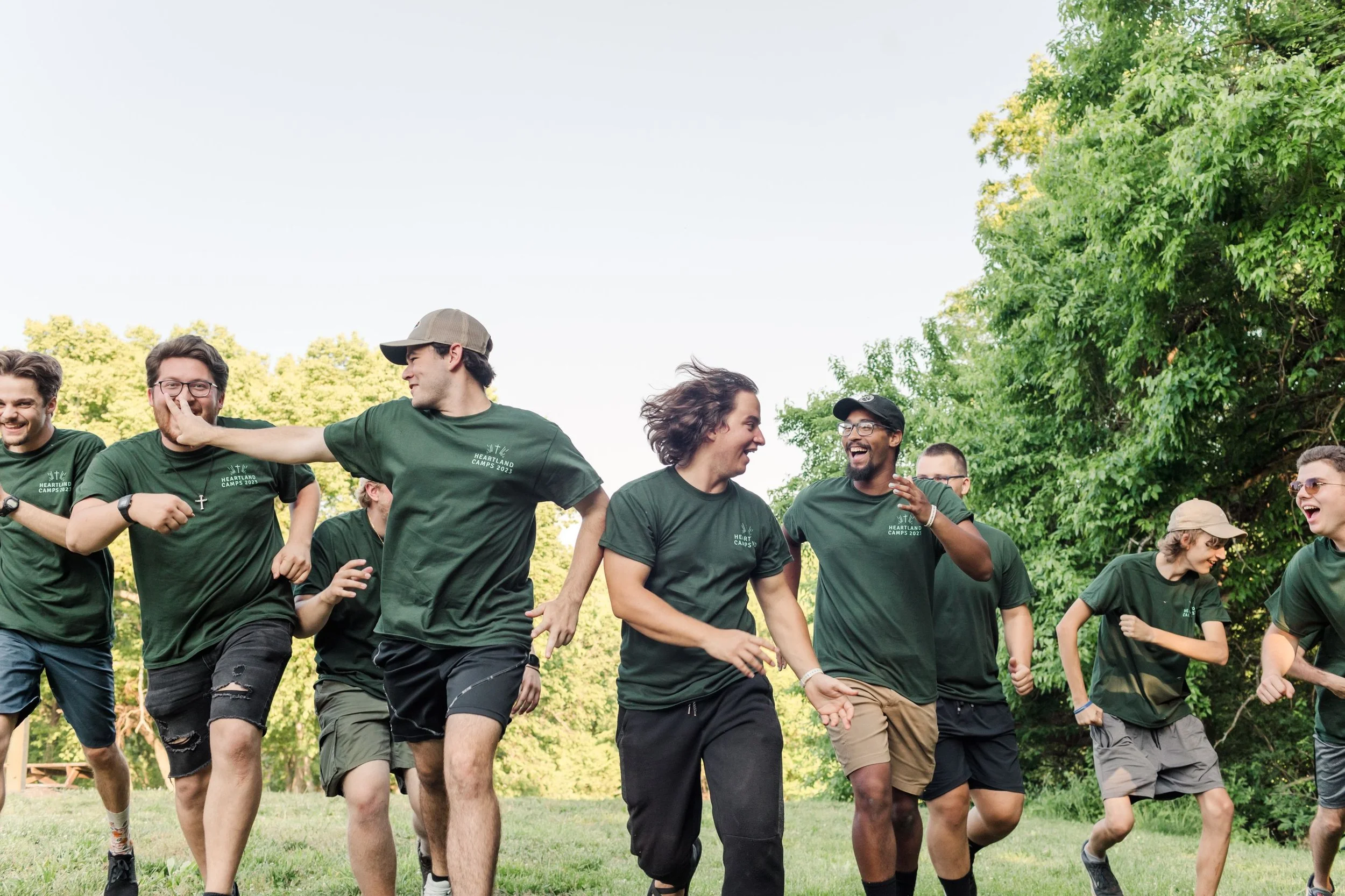 Heartland Christian Camp Paid Gap Year Internship Men running and Smiling Together Outside Near Kansas City, Missouri