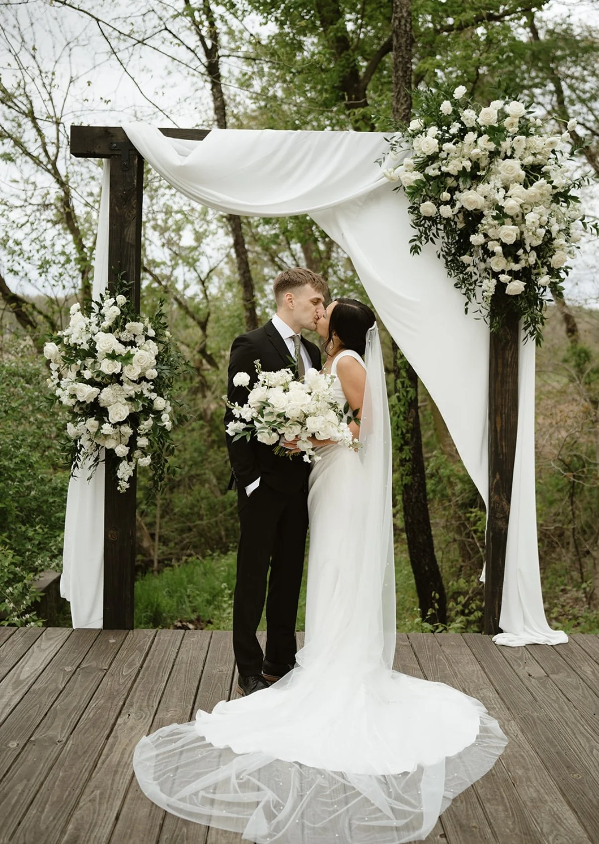Bride and Groom under Floral Arch