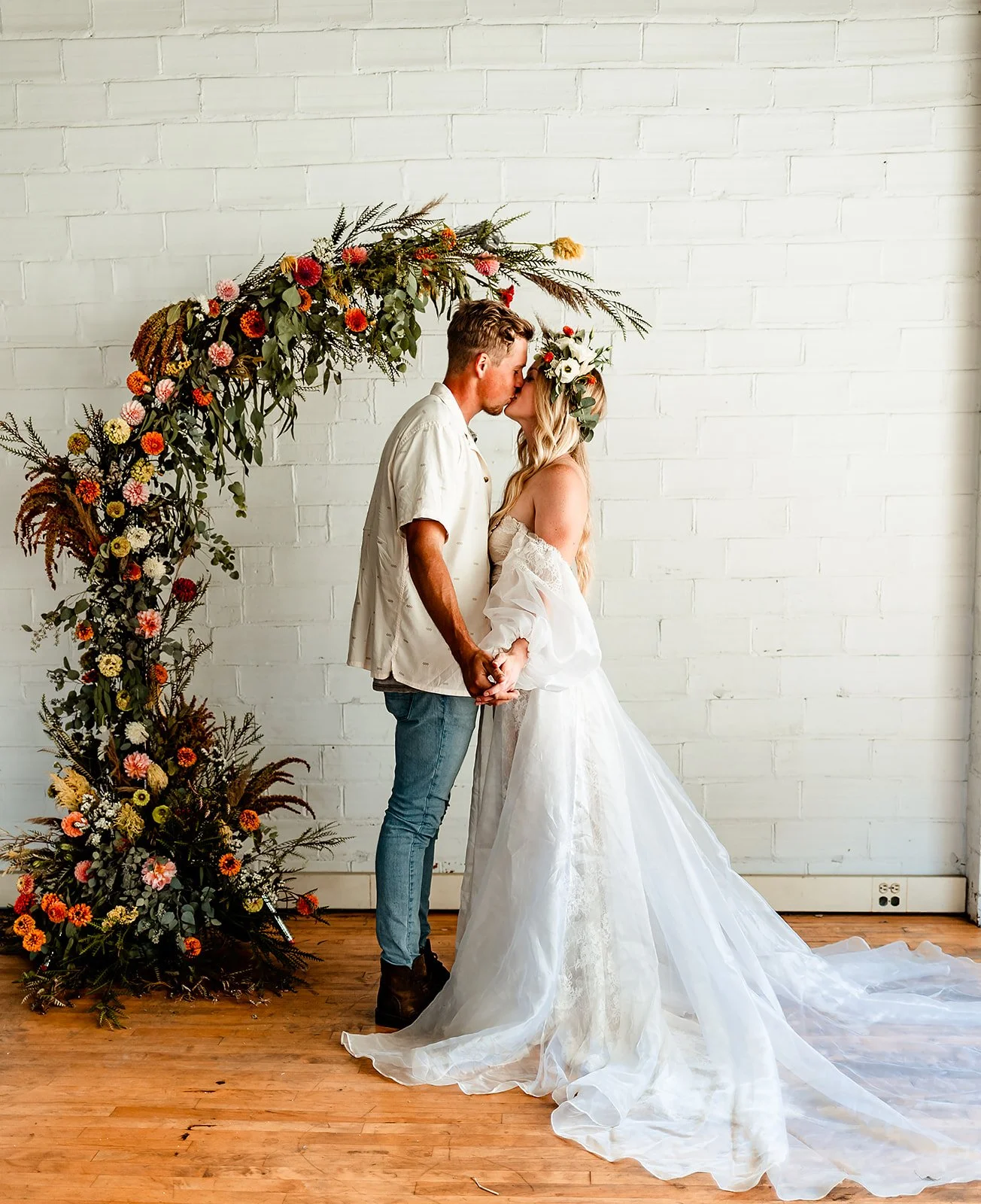 Couple Kissing with a Floral Arch behind them