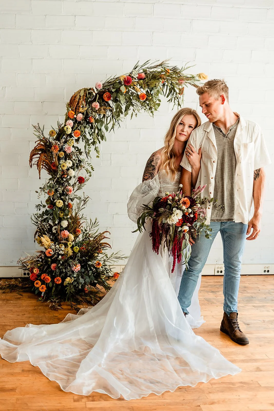 Wedding couple with Floral Arch in the Background