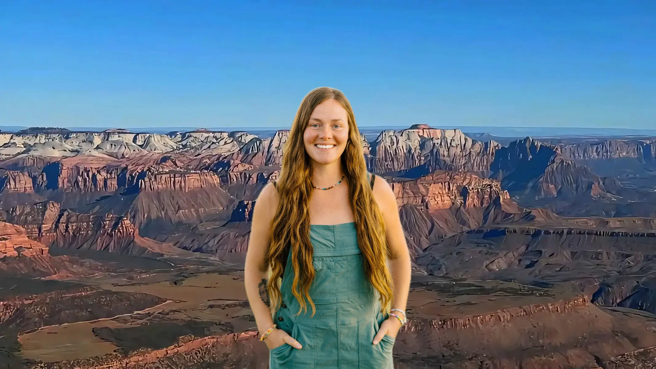 Desert landscape with red rock formations, a distant body of water, mountains, and a blue sky with wispy clouds.