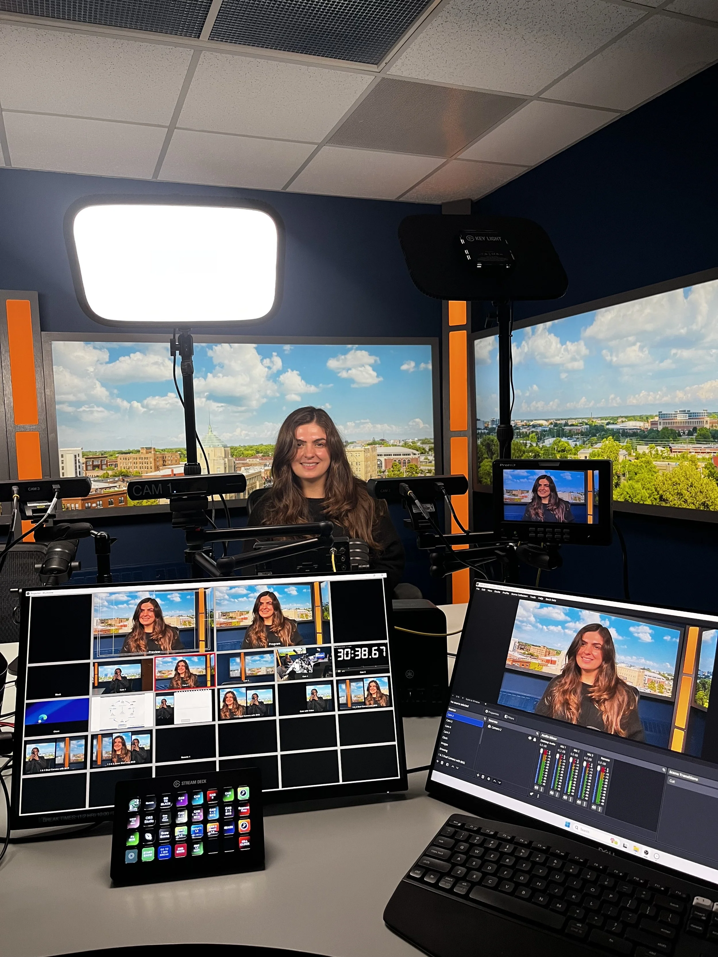  A production monitor and a laptop running OBS studio software displaying a split-screen layout of Jaelyn Vickery and Grace Ganley during their Finance Fitness Finesse media recording session. 