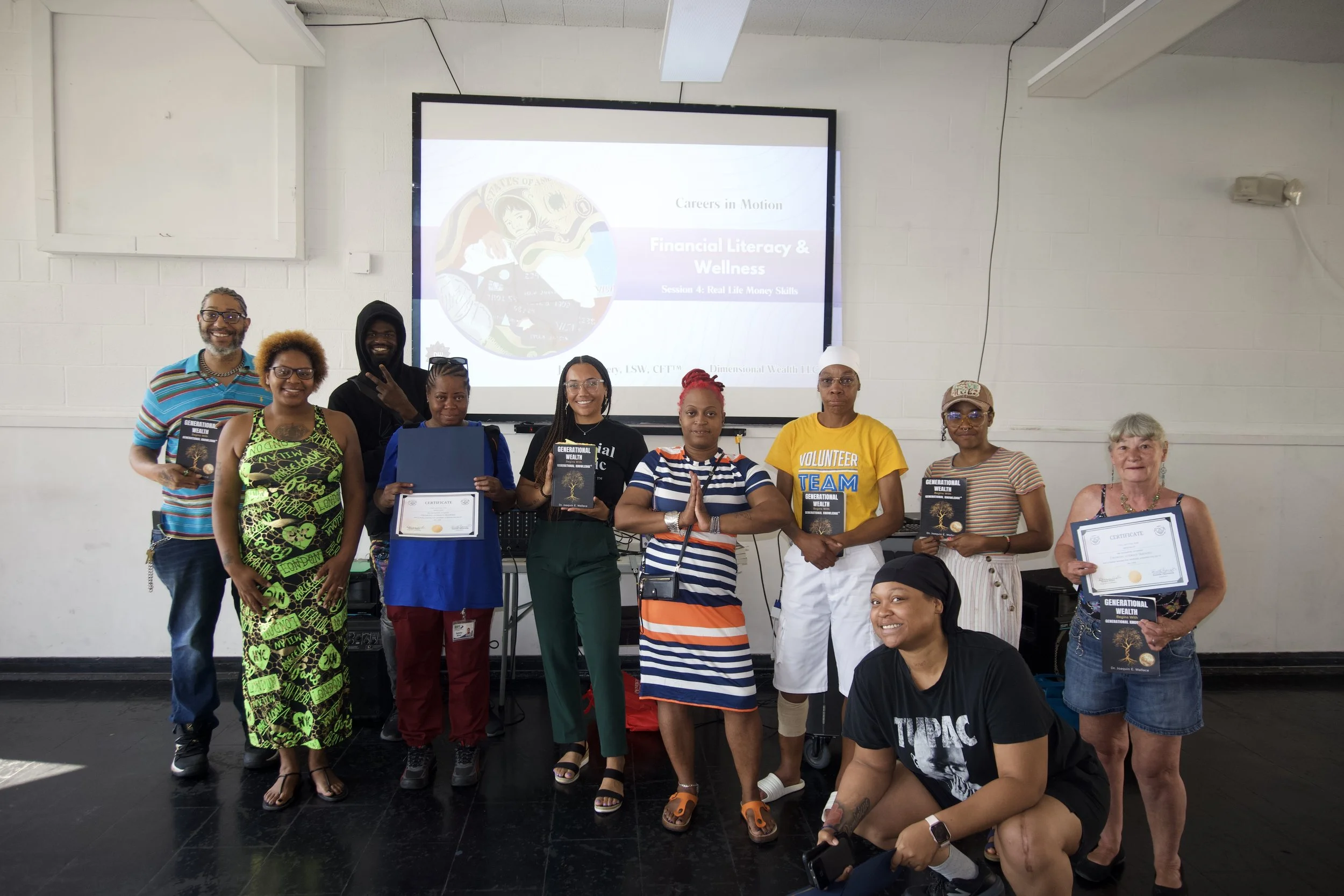 Group photo of program participants and Jaelyn Vickery holding certificates and copies of the book Generational Wealth.