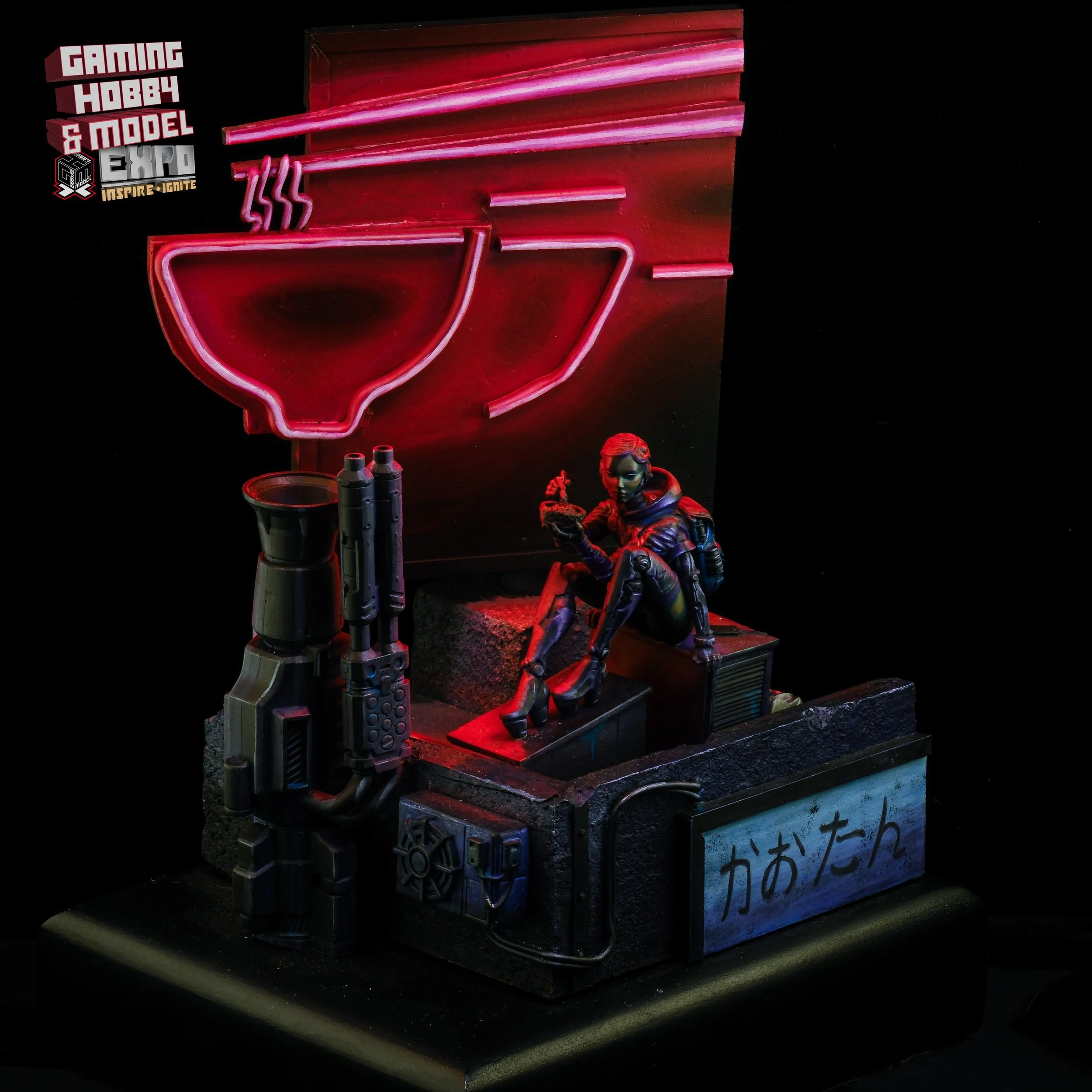 Neon-lit miniature diorama featuring a female figure sitting on a box, holding a small animal, with a neon drink sign in the background and Japanese characters on a sign in the front.