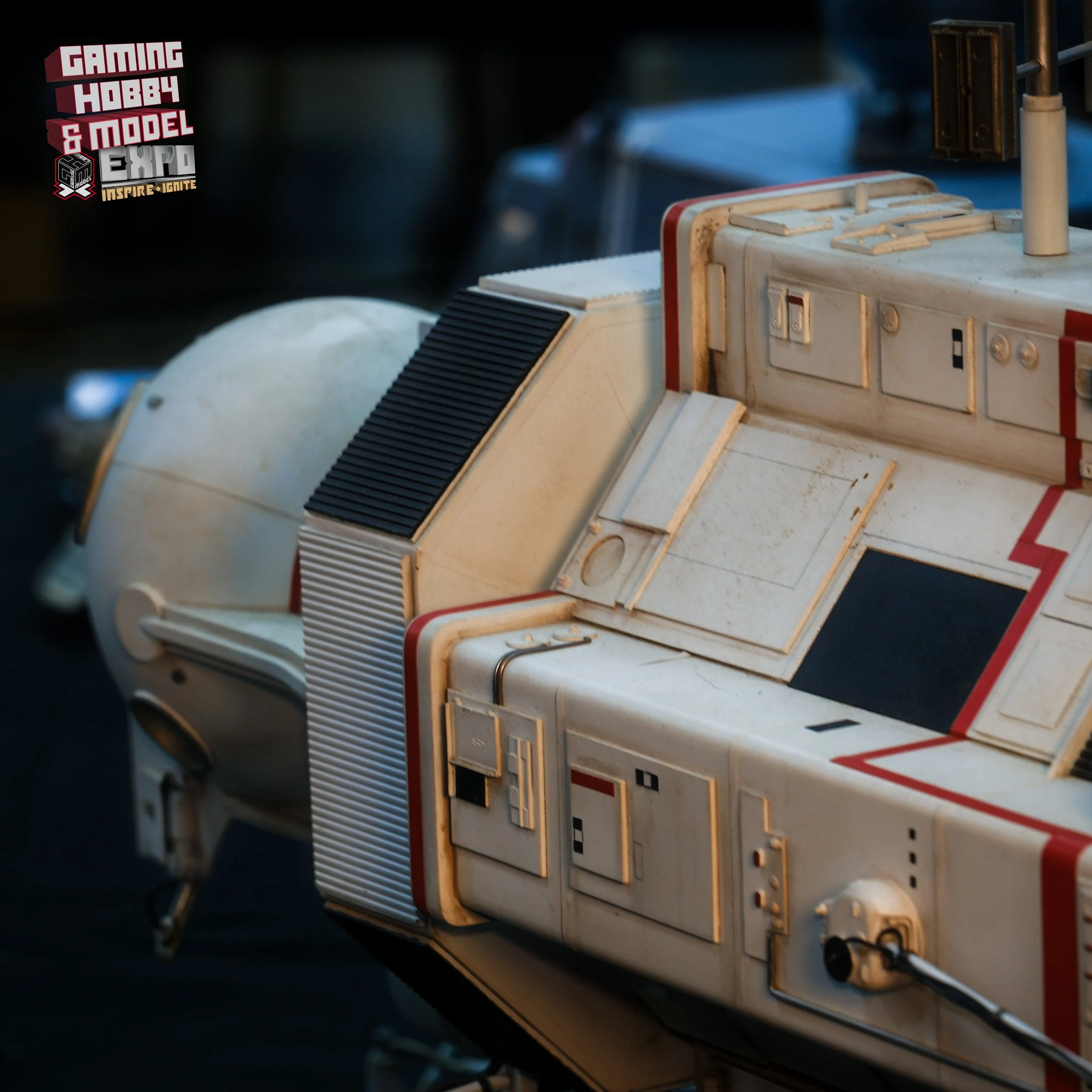 Close-up of a vintage Moon rover used in space exploration, featuring a white body with red accents and various panels and controls.