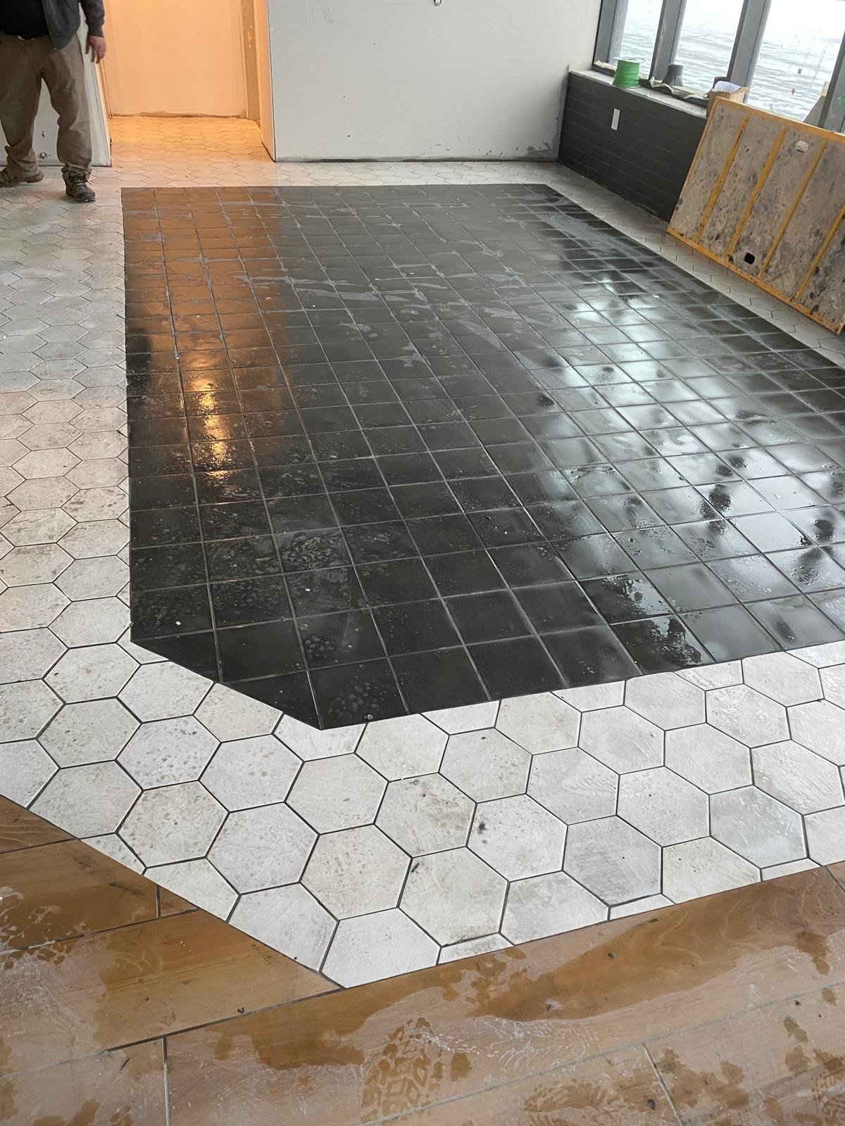 Modern wooden house with large window in mountainous landscape