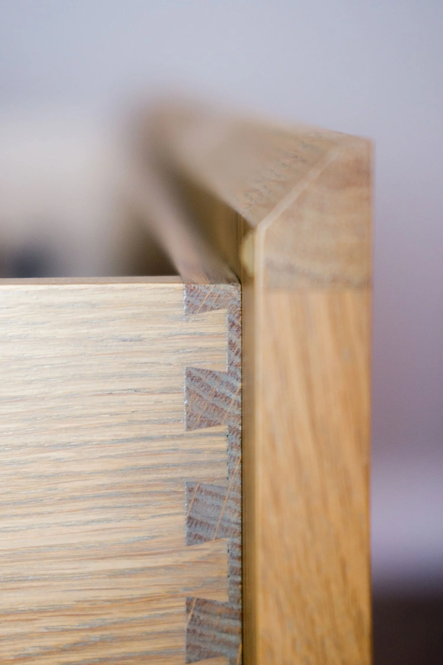 Close-up of the edge of a wooden drawer with dovetail joints.