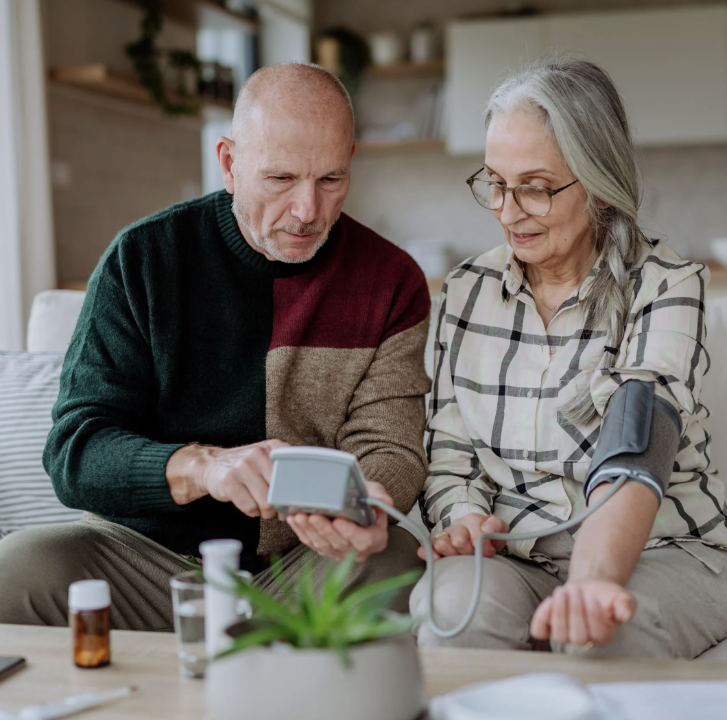 Man checks womans blood pressure
