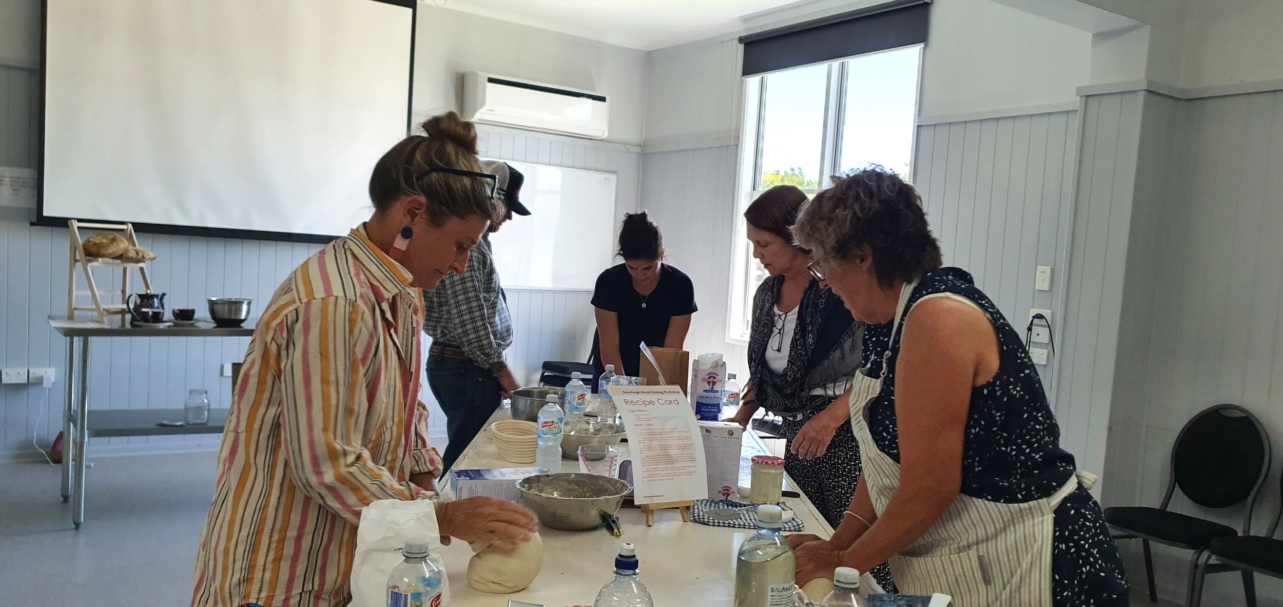 breakingbreadworkshopmembersyarningoverbreadmaking