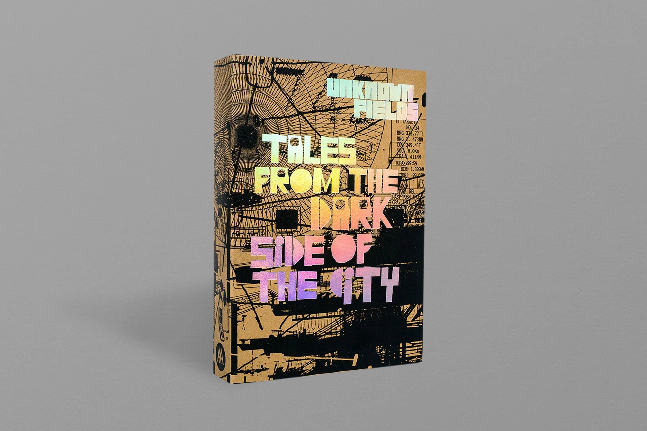 Book titled "Tales from the Dark Side of the City" with a holographic cover design and abstract cityscape illustration.