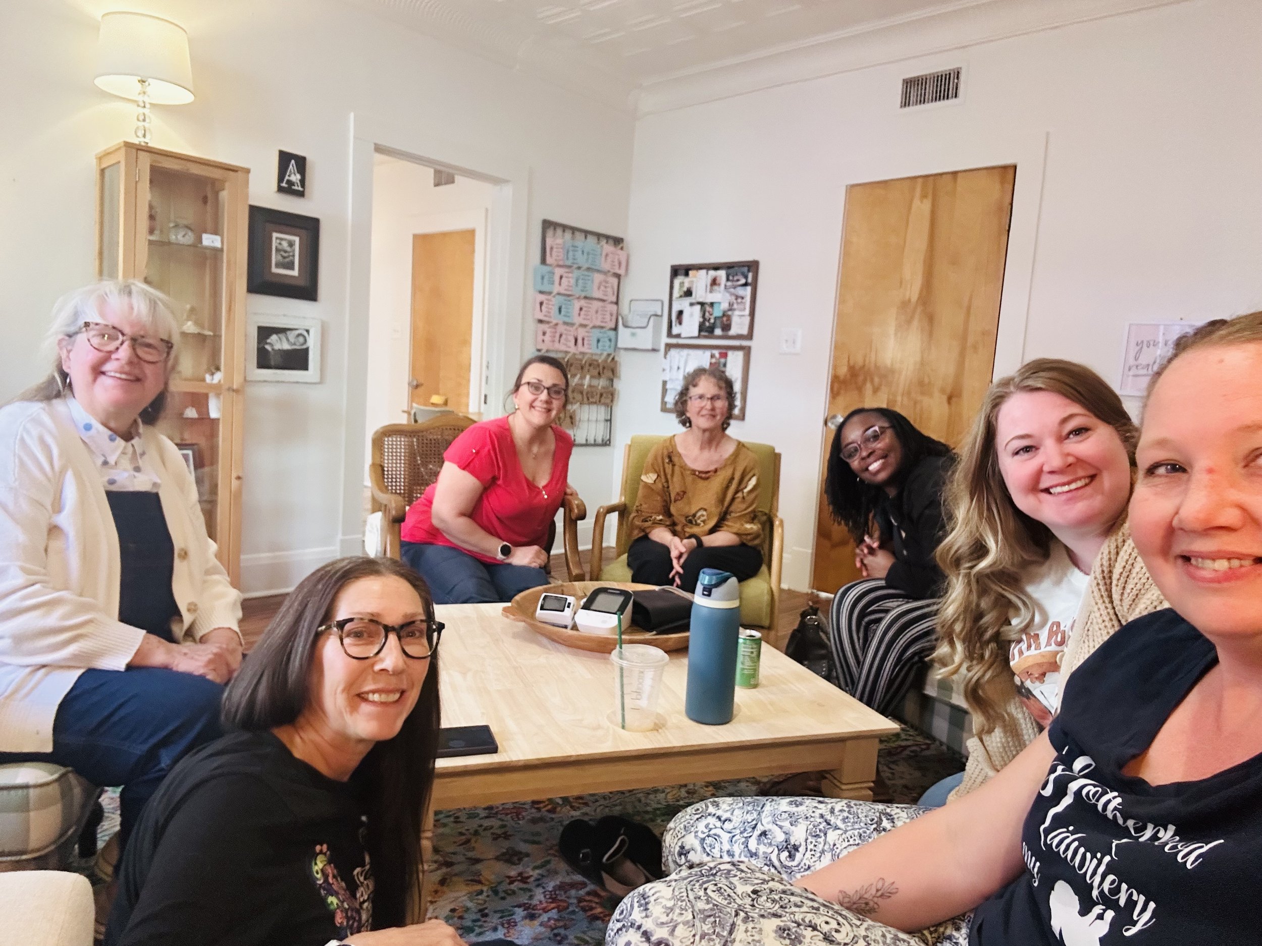 Texas Midwives gathered together encouraging one another.