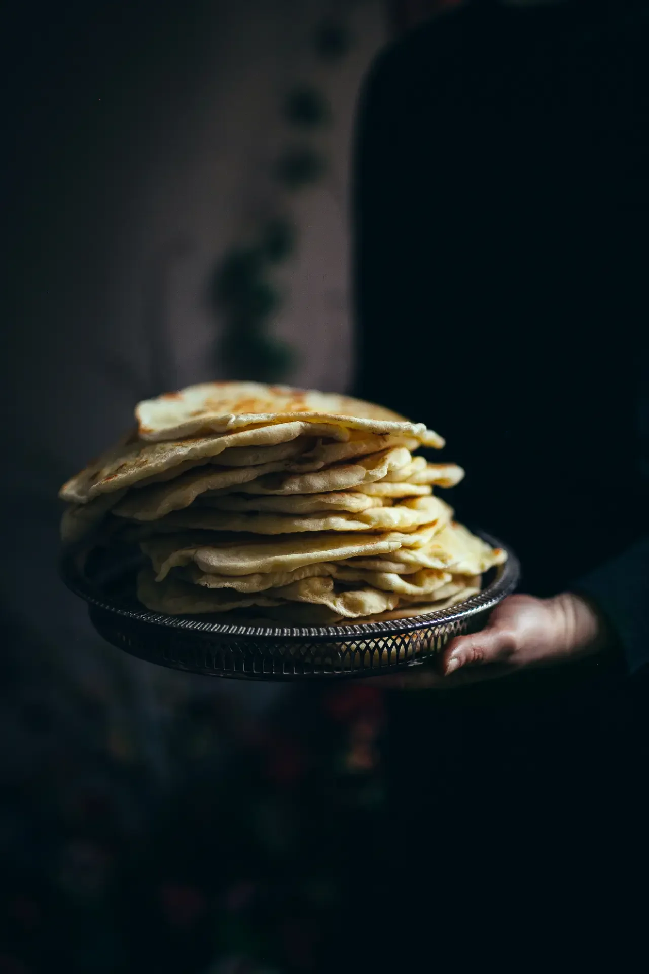Stack of freshly baked flatbreads served for Mediterranean mezze gathering