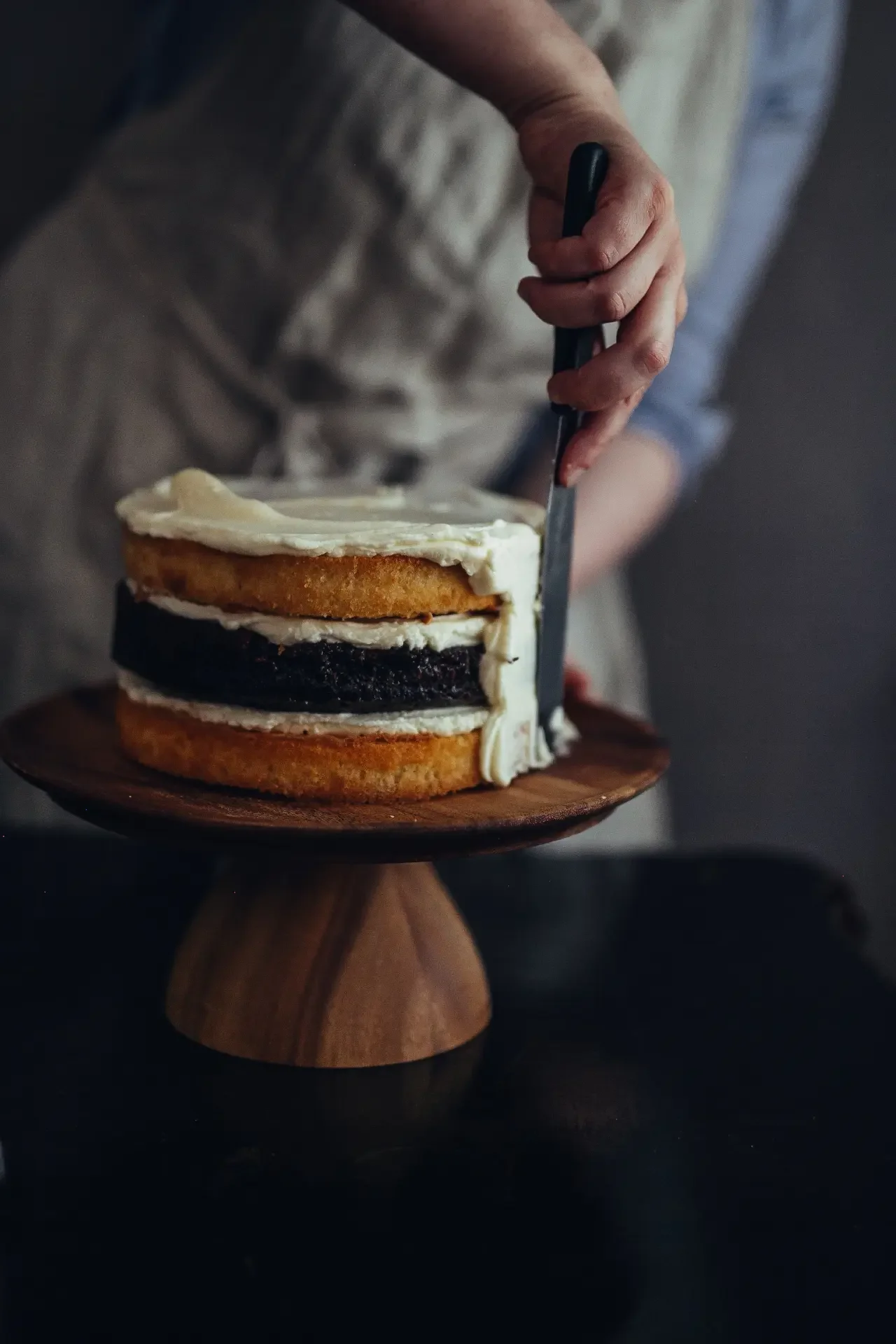 Covering with cream a freshly baked tahini cake