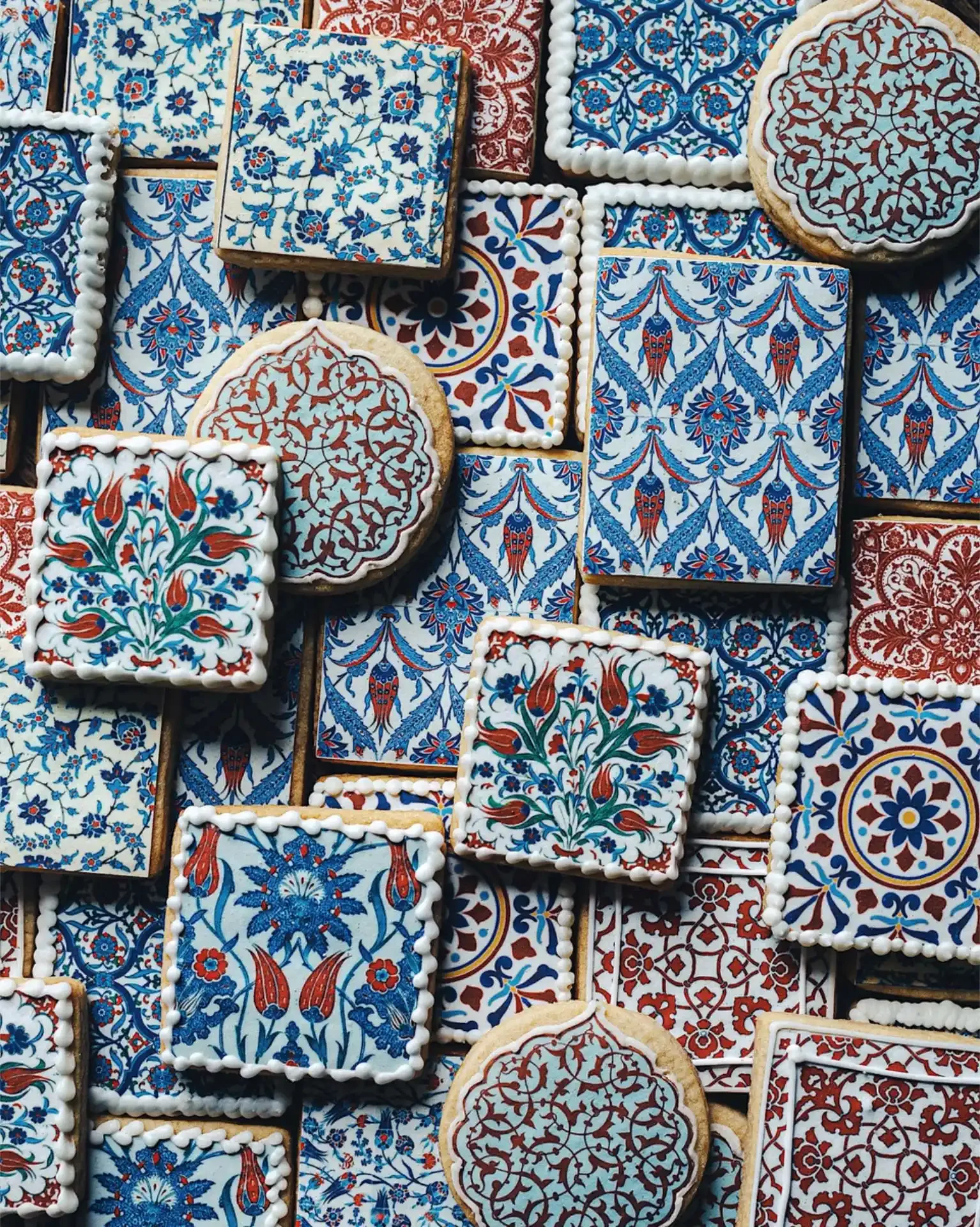 Decorative cookies with intricate blue, red, and white patterns resembling traditional tile designs.
