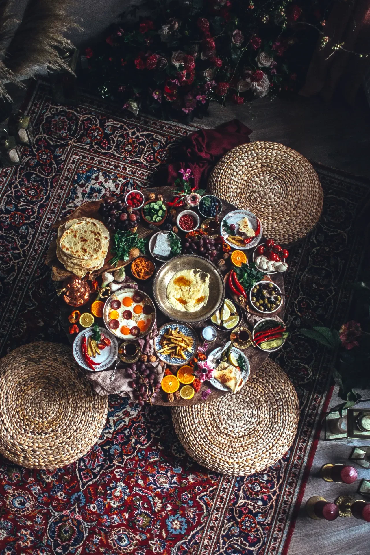 Overhead view of Turkish sofra with mezze bowls, dips and freshly baked brea
