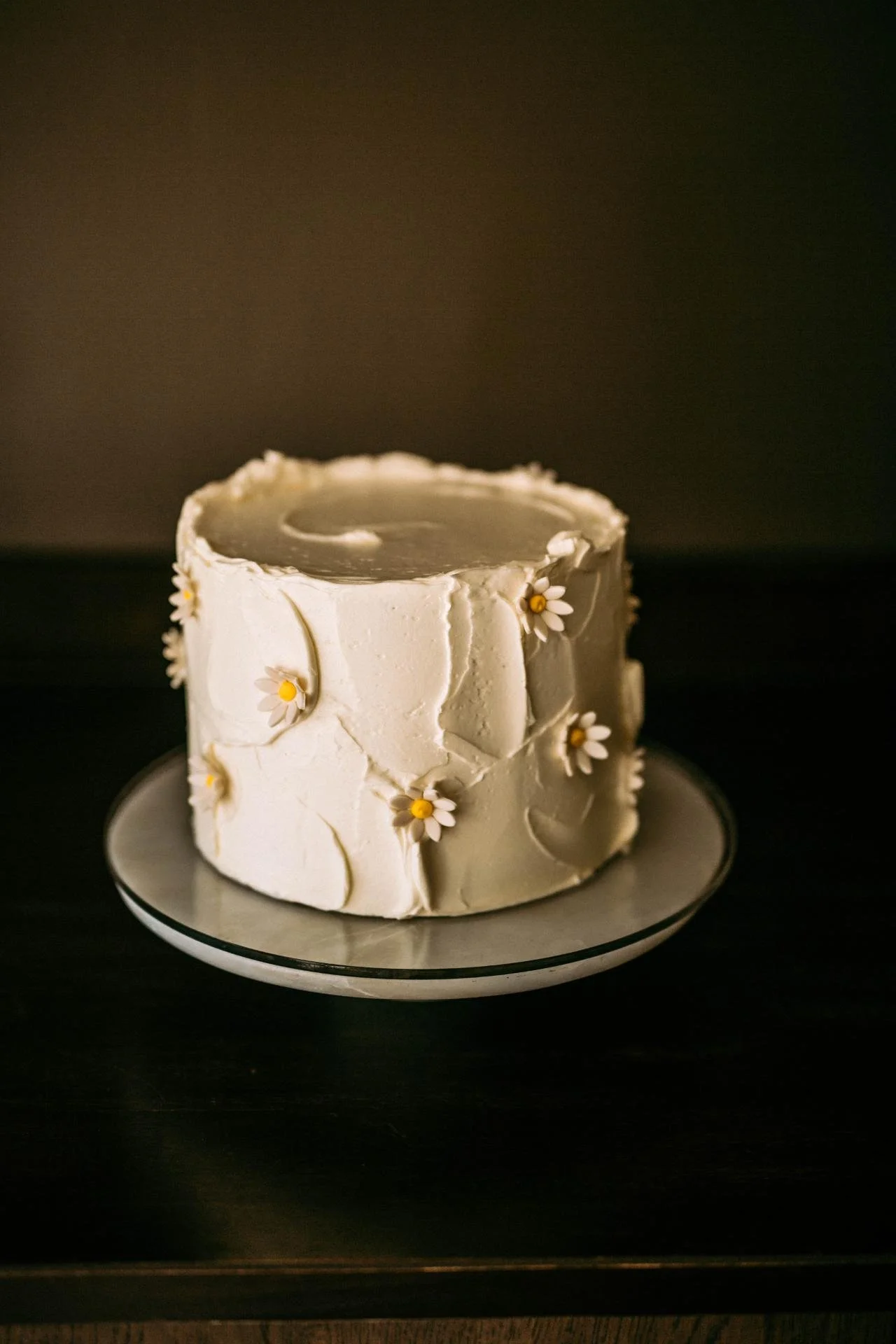 Custom birthday cake with buttercream and daisy decorations