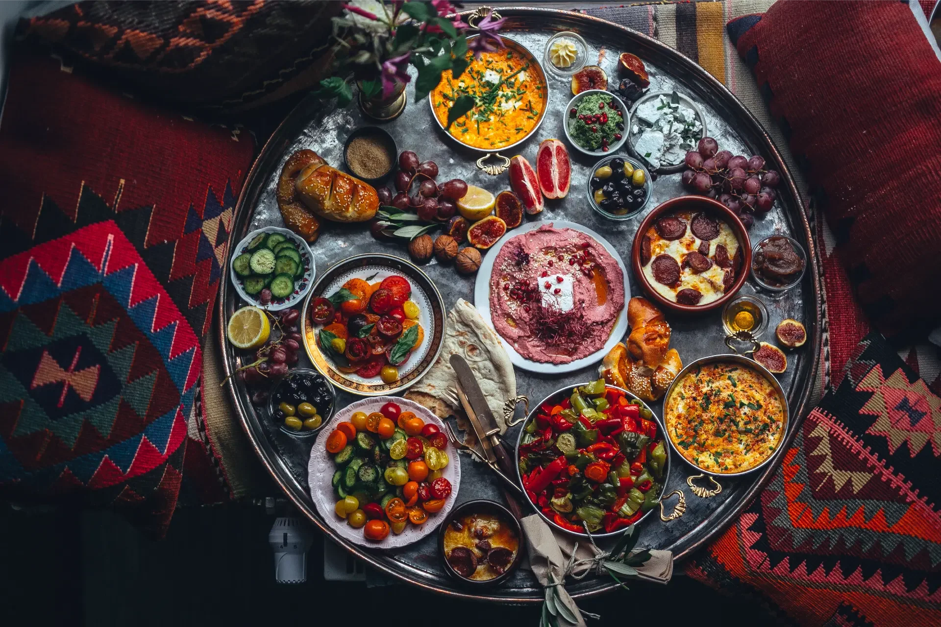 Luxury Mediterranean breakfast table with mezze dishes, fresh flowers and handcrafted textiles