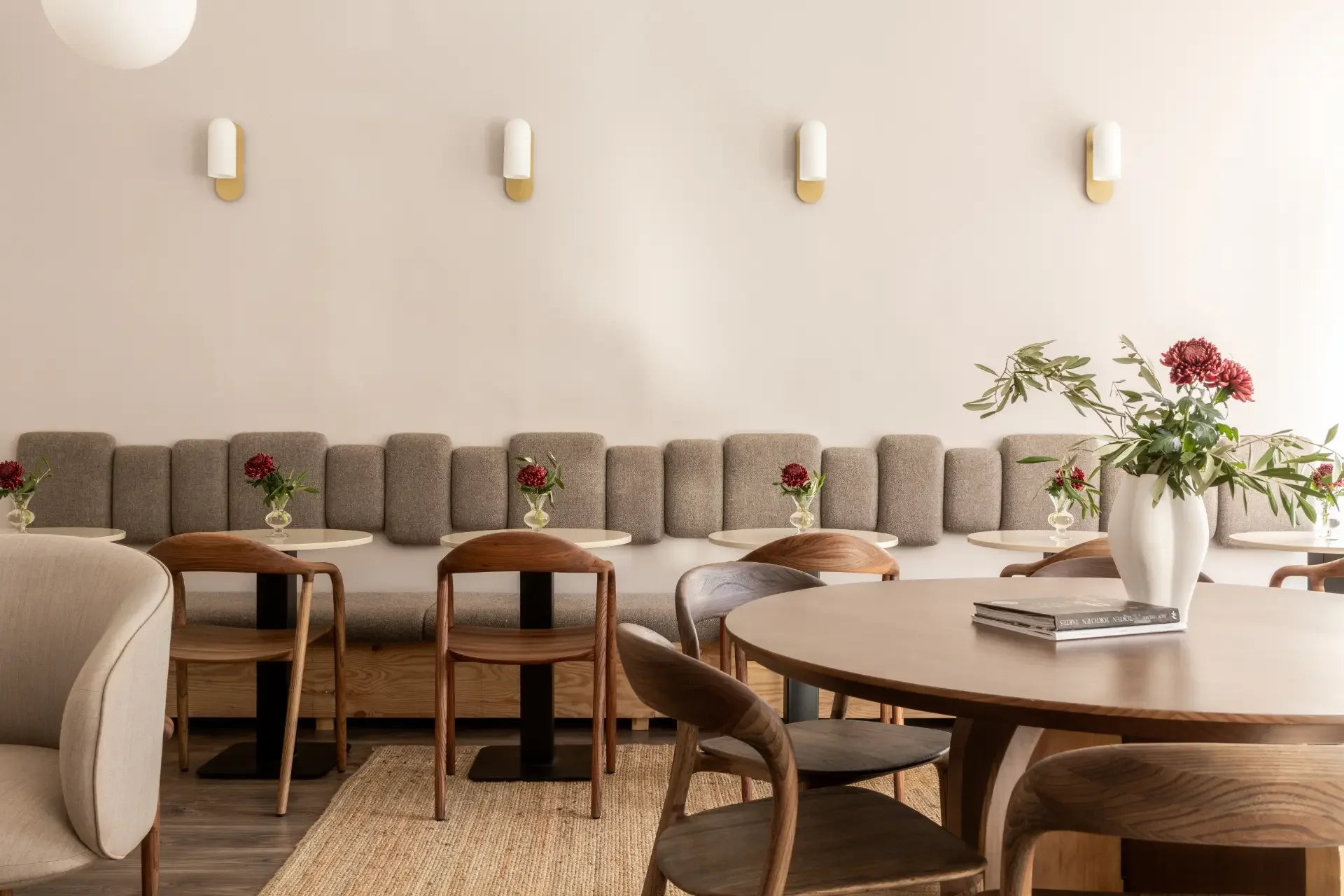 Minimalist seating area with custom furniture and roses decorations inside Dilekerei cake studio Berlin