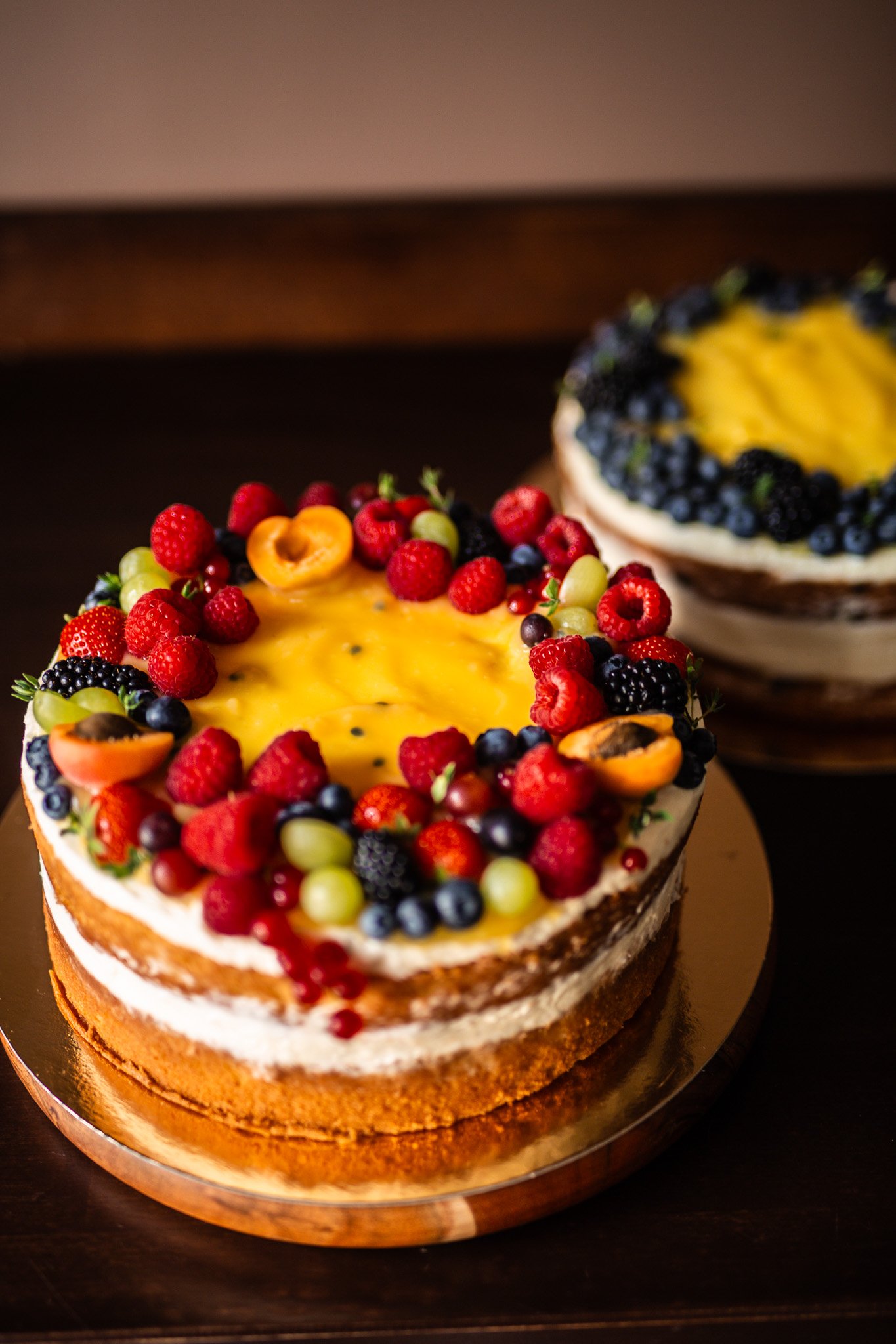Naked birthday cake topped with passion fruit and assorted fresh seasonal berries