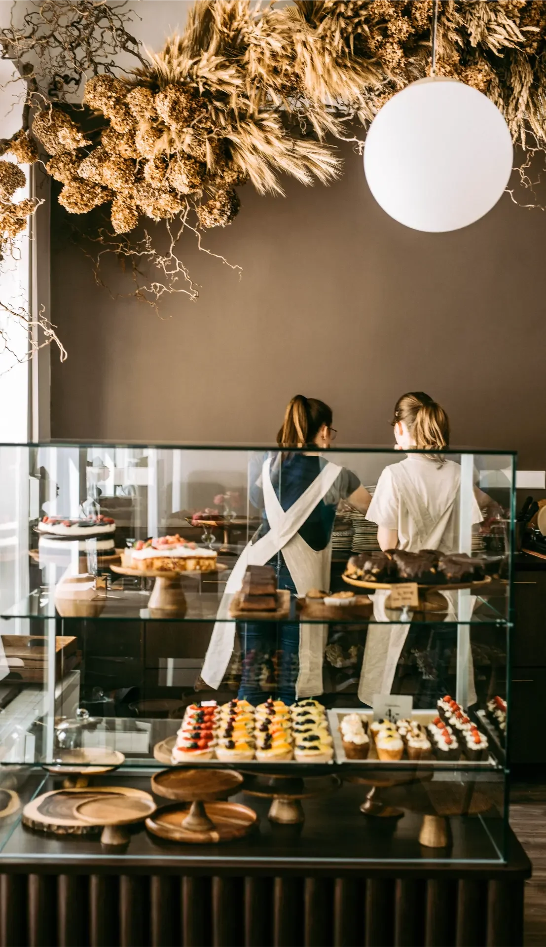 Pastry chefs working behind dessert counter at Dilekerei Berlin