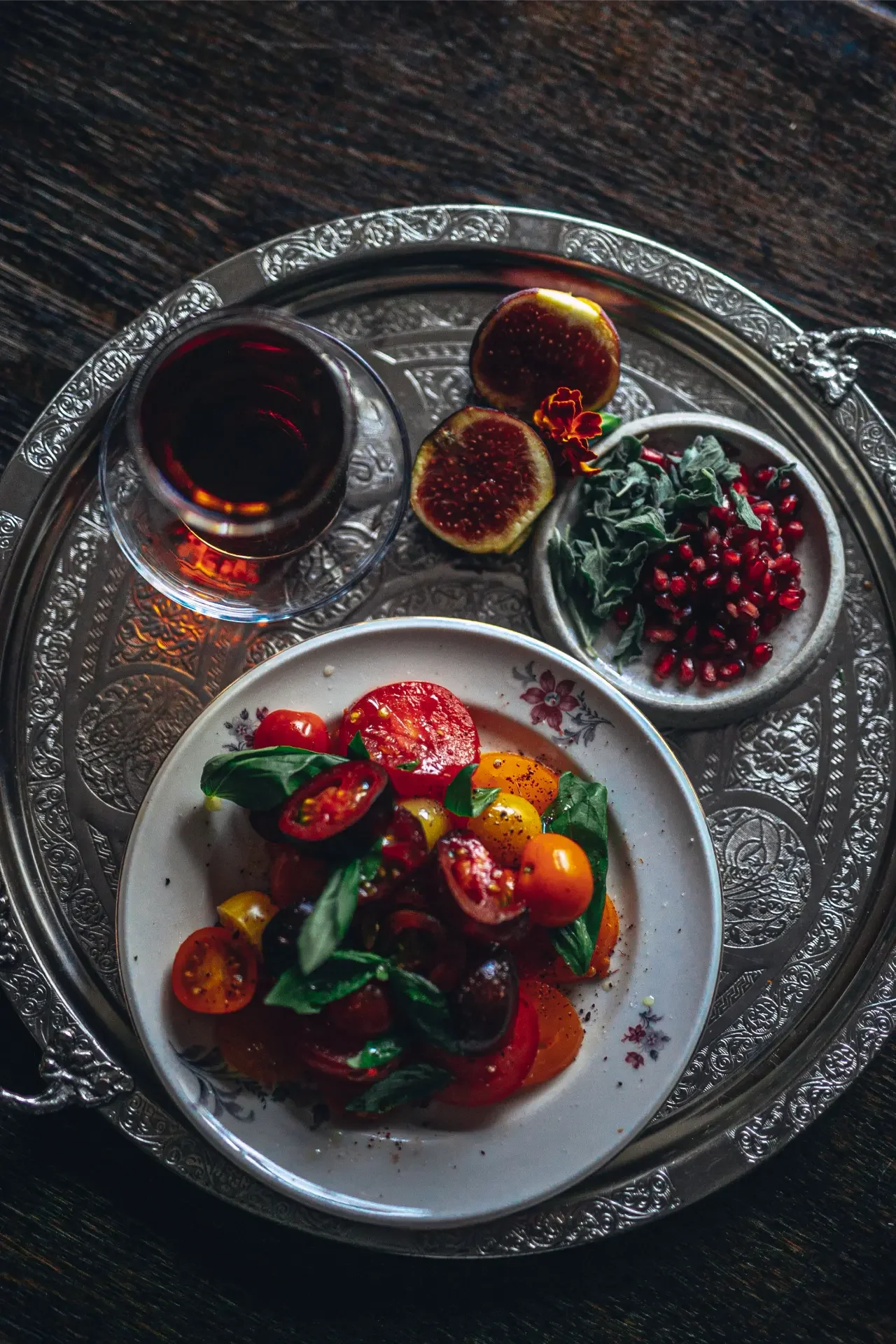 Fresh strawberries, pomegranate and Turkish tea served on decorative metal breakfast tray