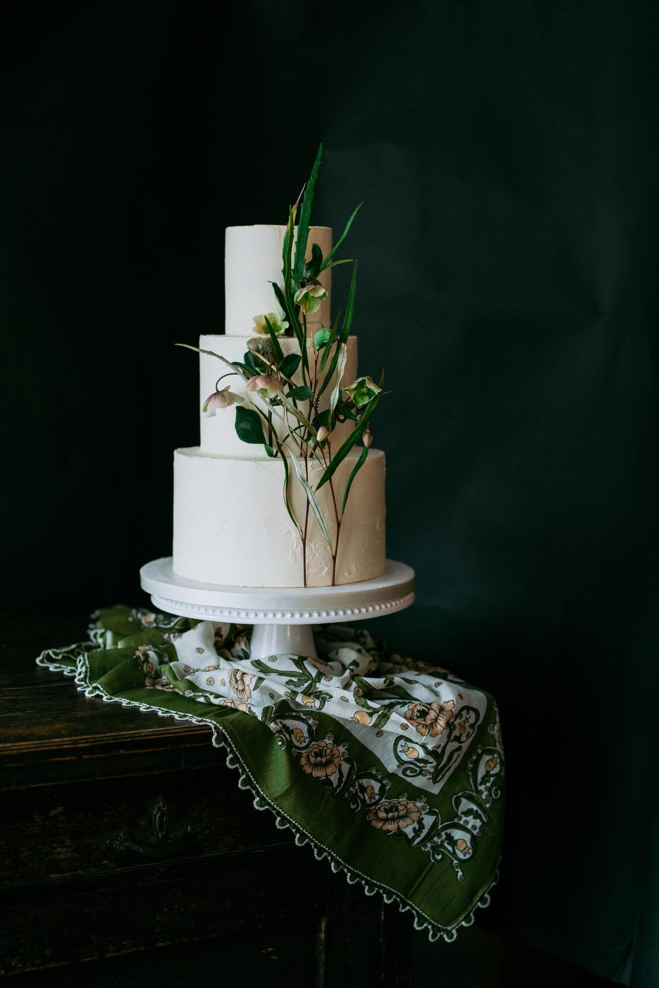 a beautiful and elegant wedding cake decorated with flowers at dilekerei bakery in berlin