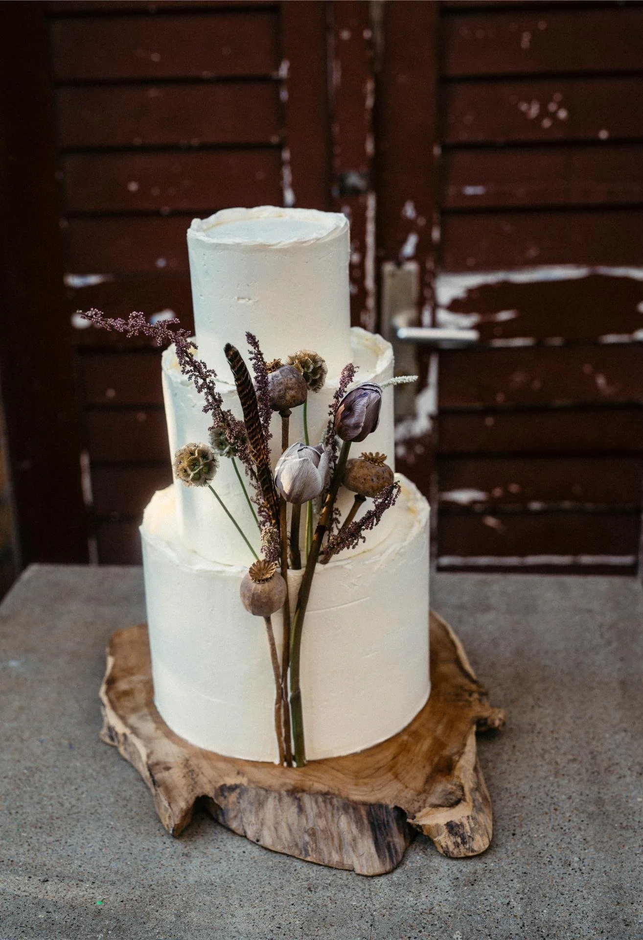Modern white wedding cake with natural dried floral and botanical decoration
