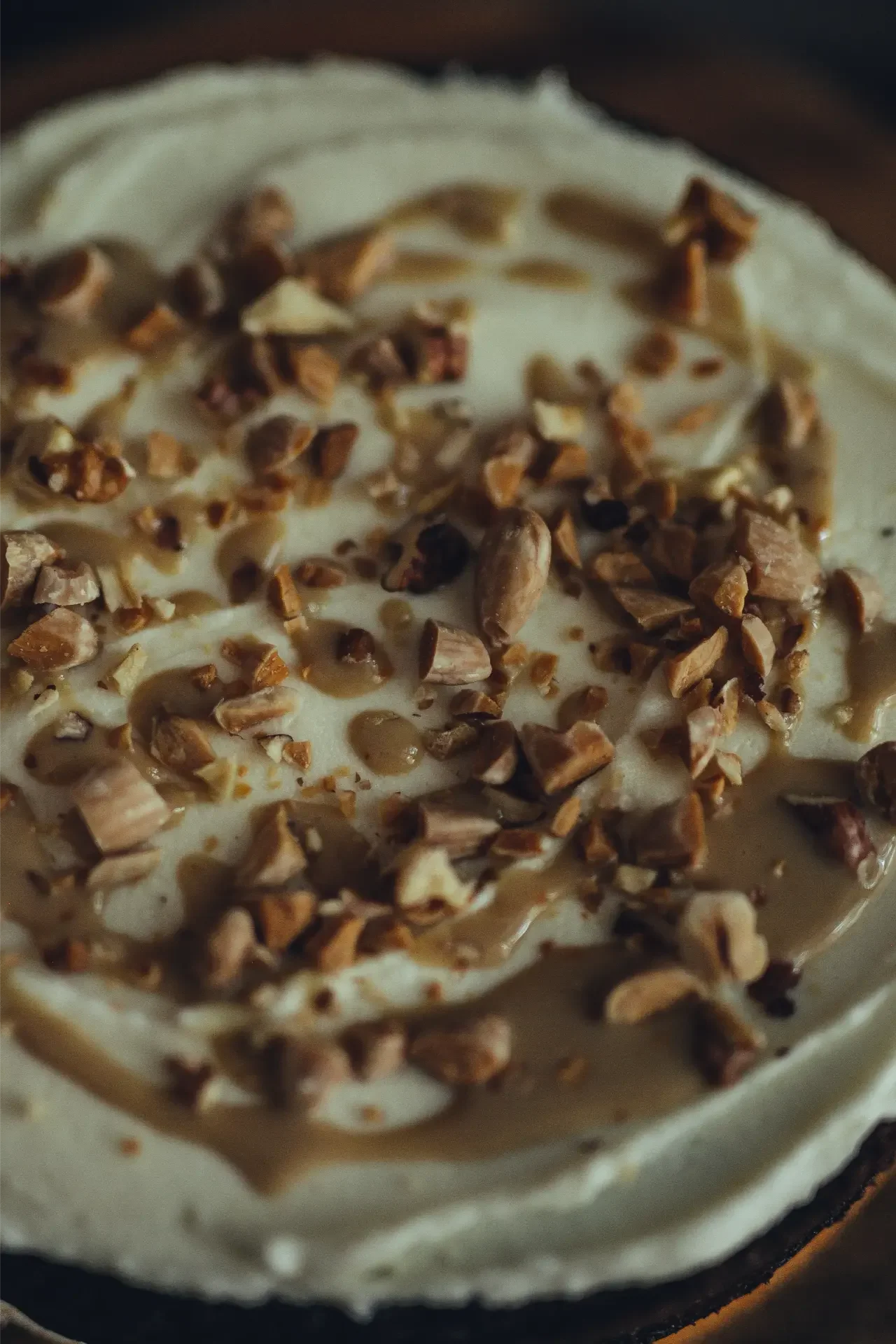 Close-up of tahini cake with toasted nuts decoration