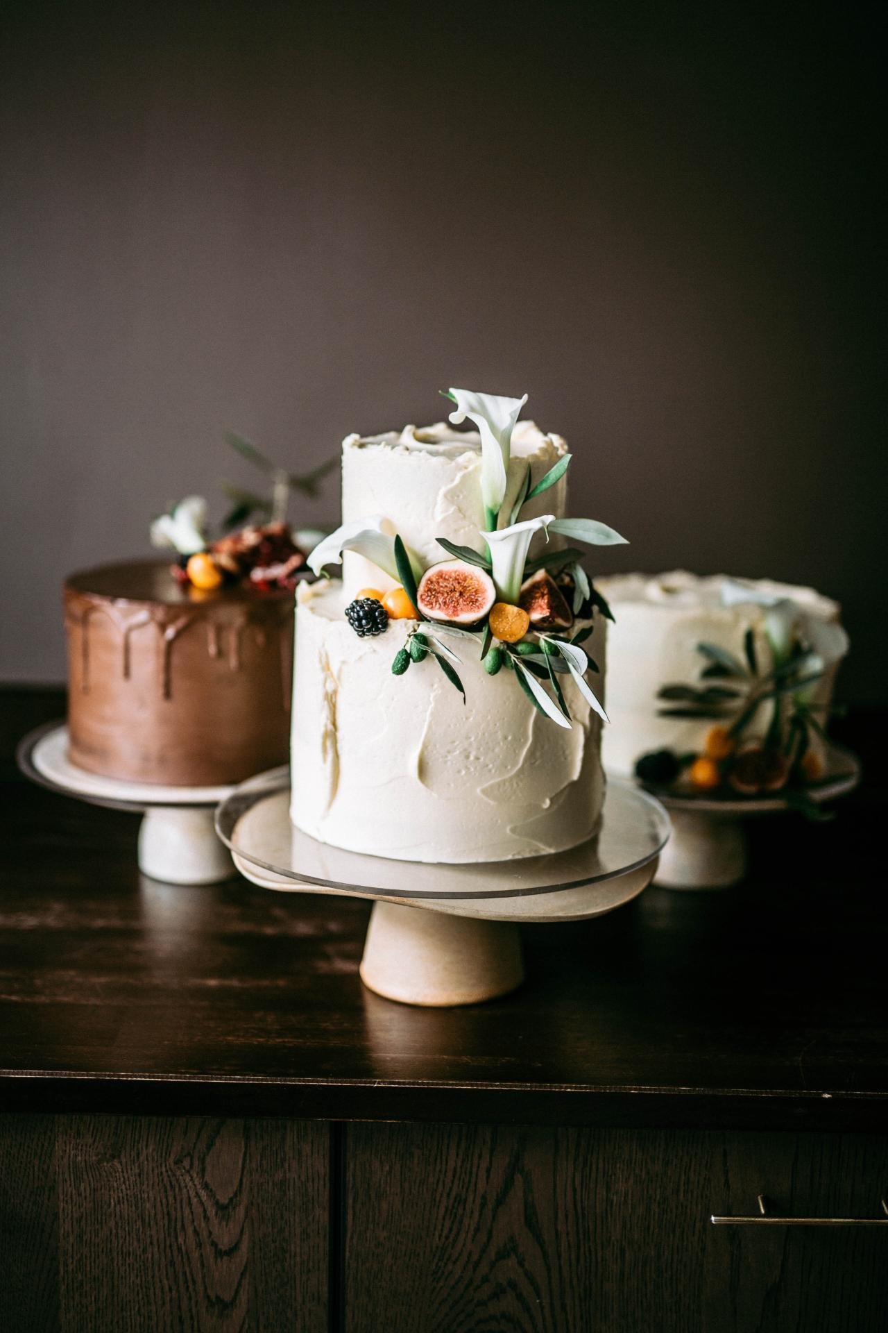 Trio of handcrafted wedding cakes with fresh floral decorations by dilekerei Berlin
